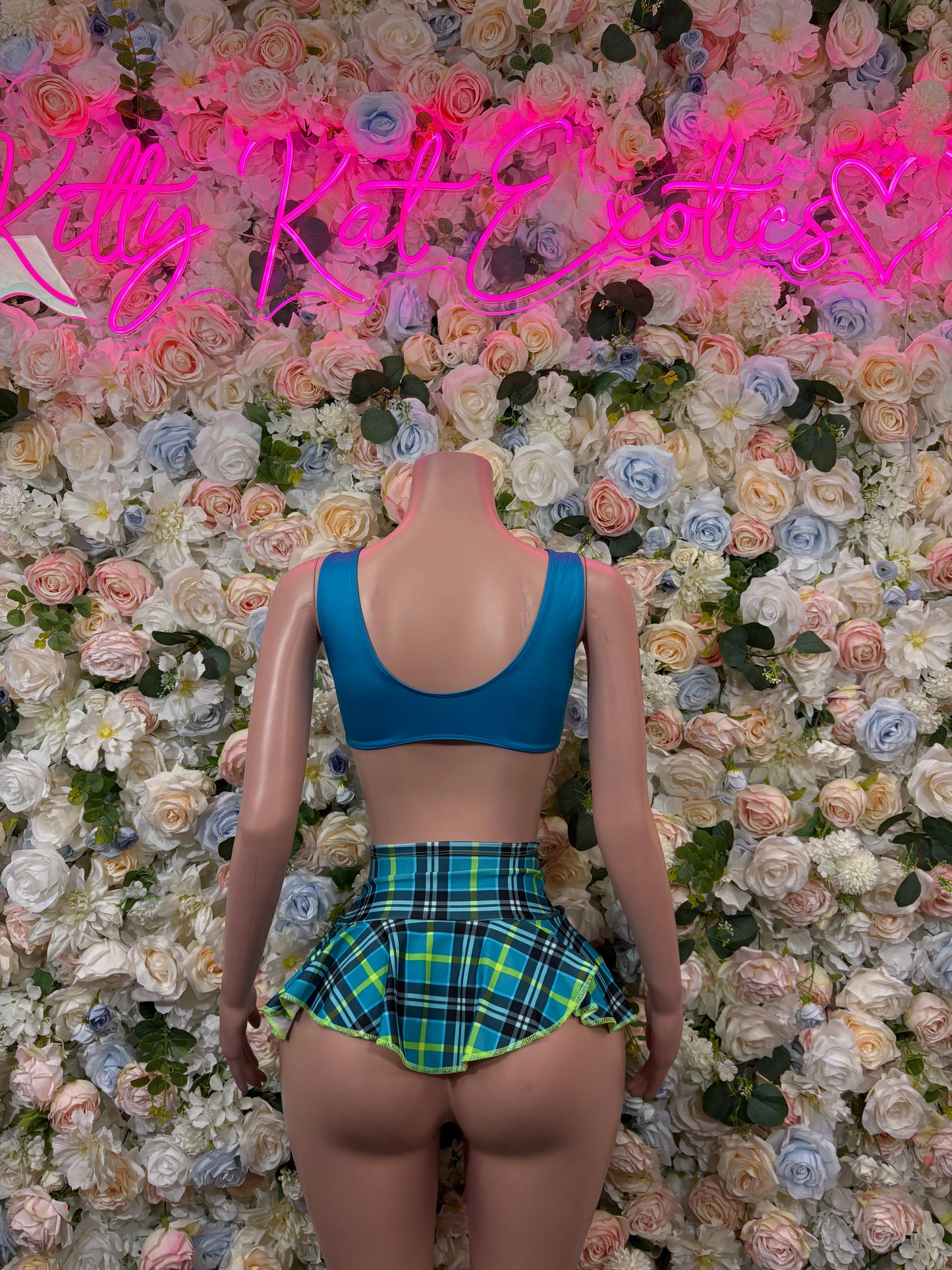 Back view: blue scoop bra top with green plaid pleated mini skirt set