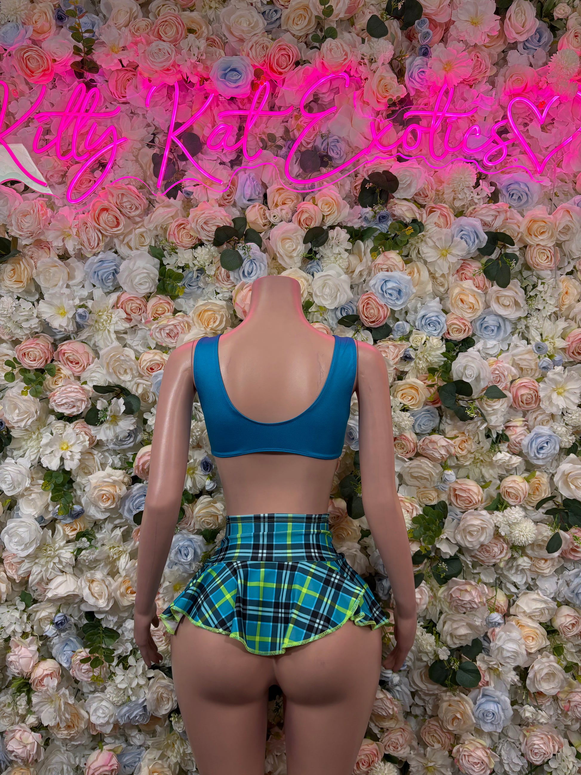 Back view: blue scoop bra top with green plaid pleated mini skirt set