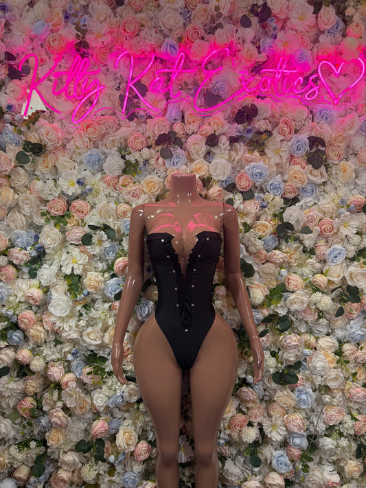 Black one-piece bodysuit with sweetheart neckline, lace-up straps, and cutout front
