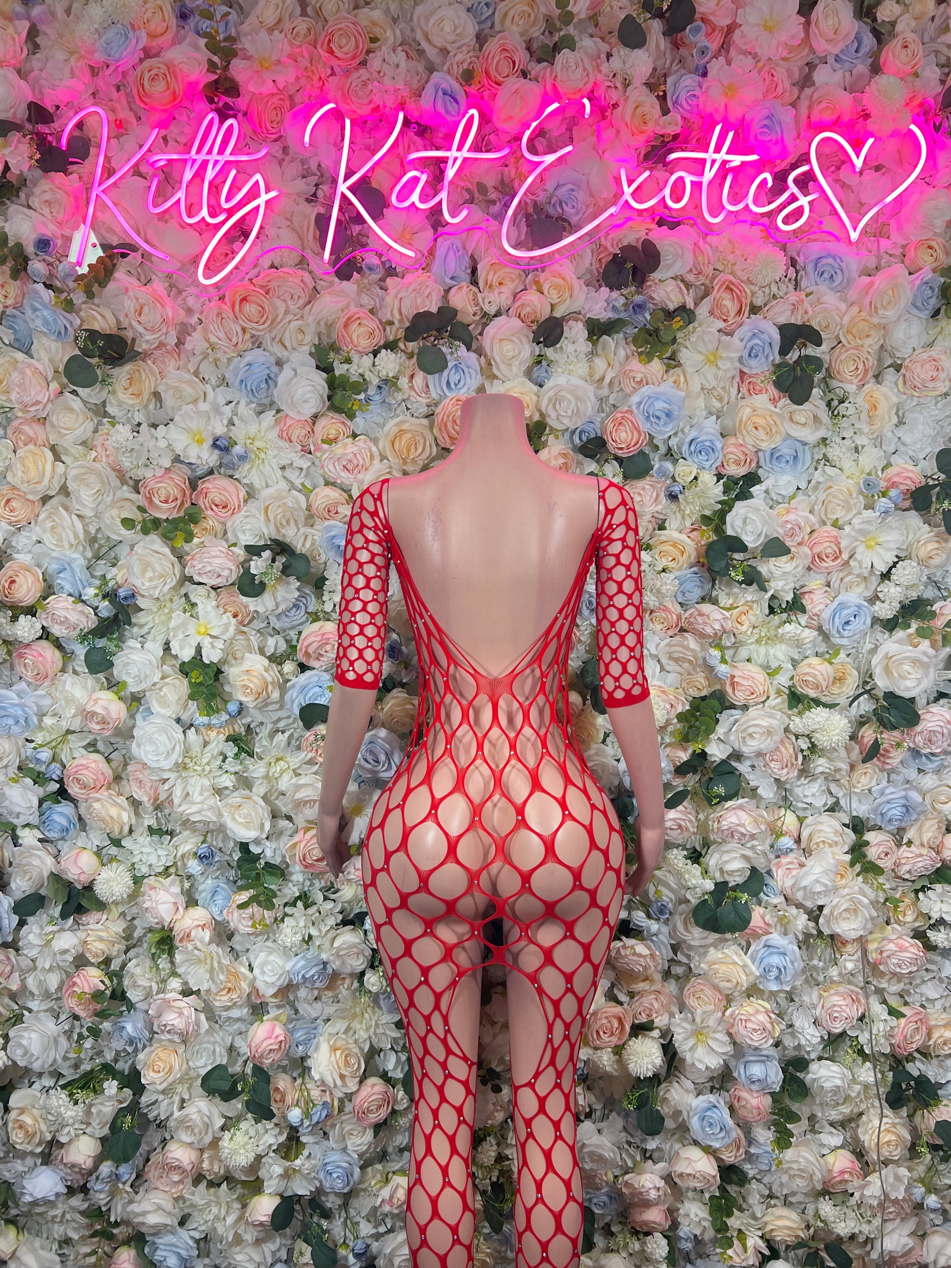 Red fishnet bodysuit with long sleeves and strappy open-back