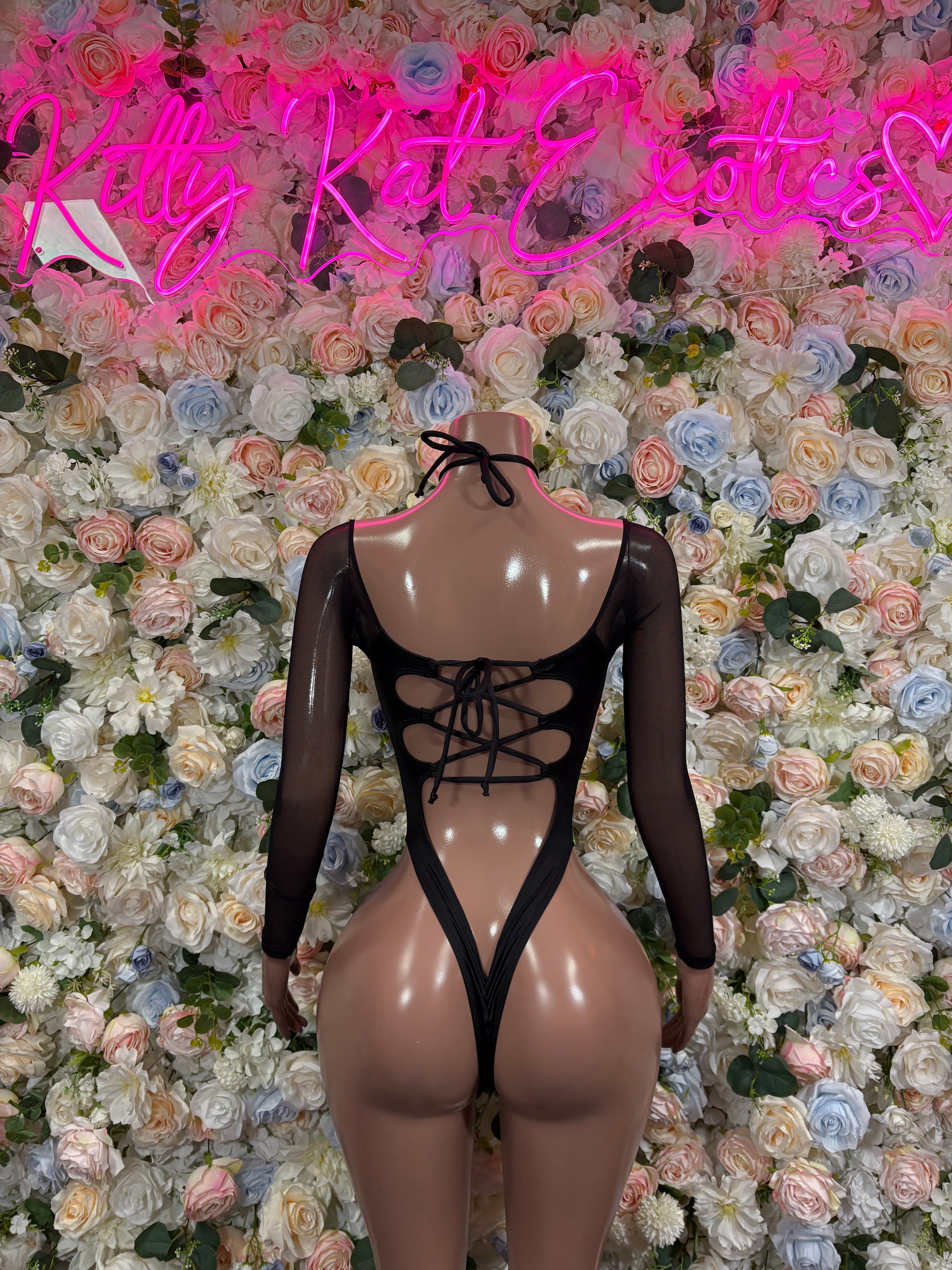 Black mesh one-piece bodysuit with neon green and yellow lightning print, open back lace