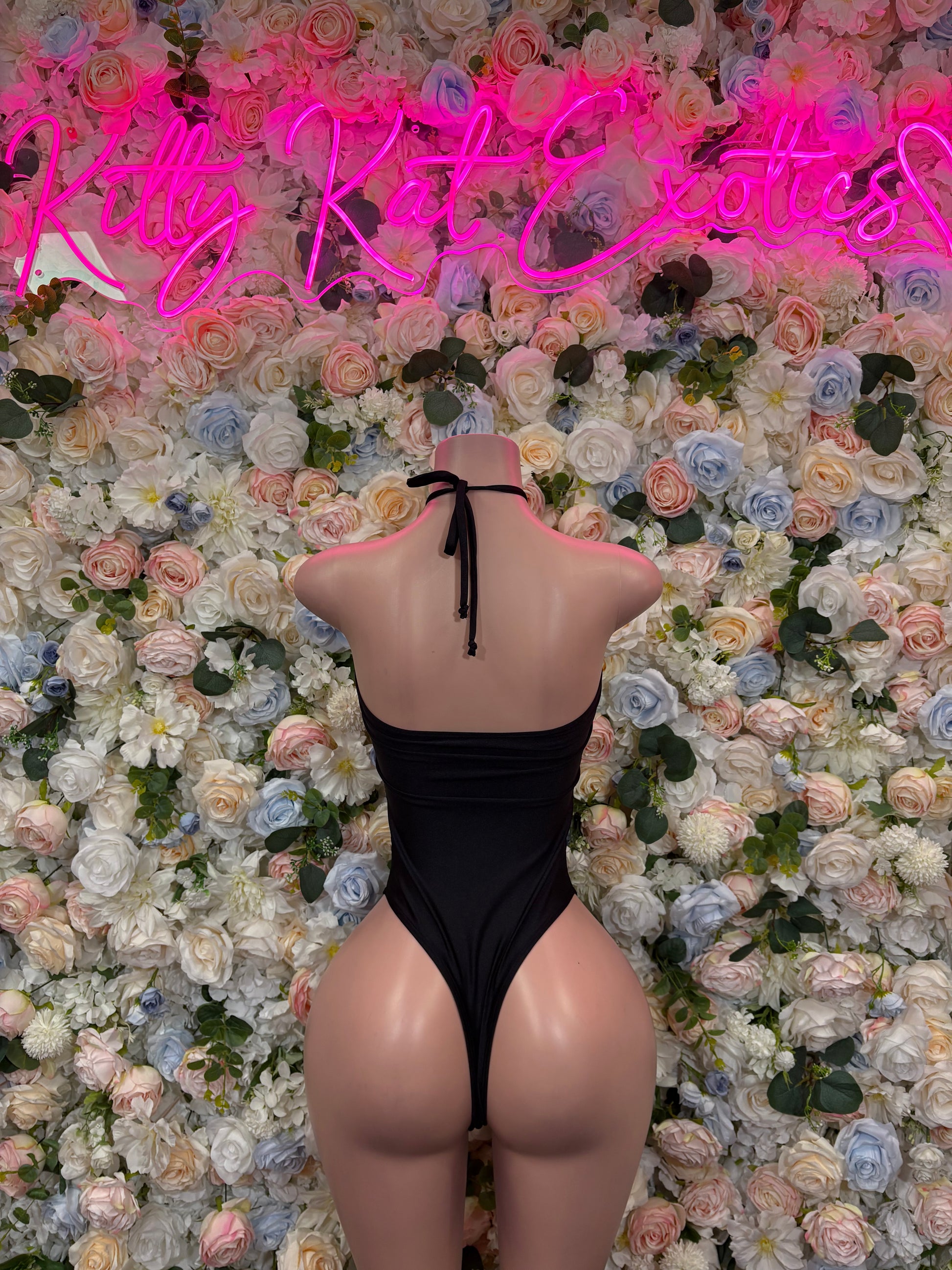 Black one-piece dance bodysuit with open back and long tie straps