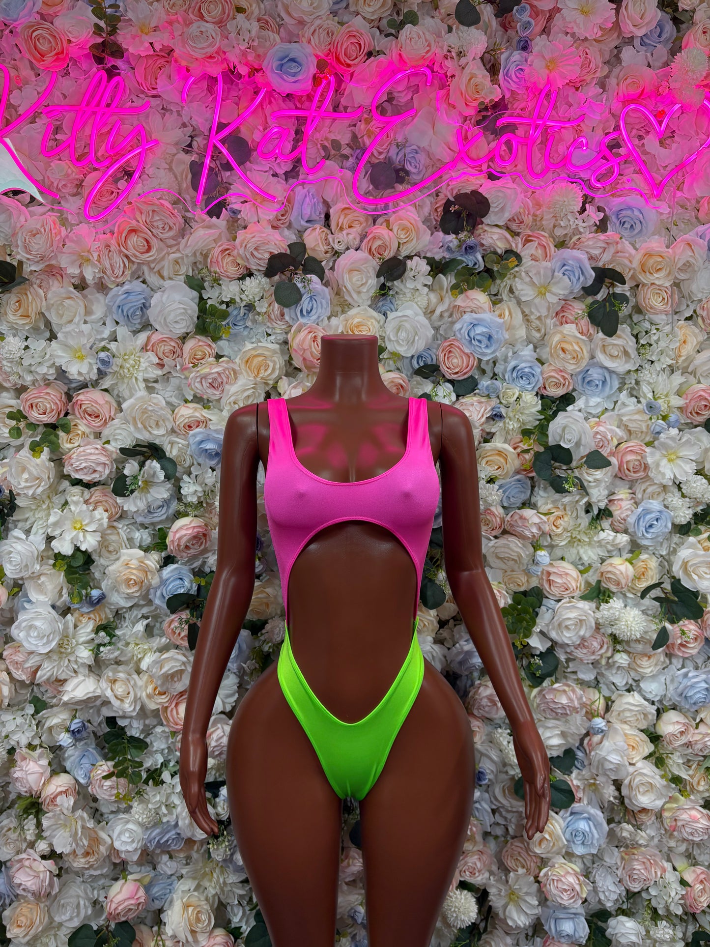 Pink and neon green sleeveless bodysuit, high-cut legs and scoop back