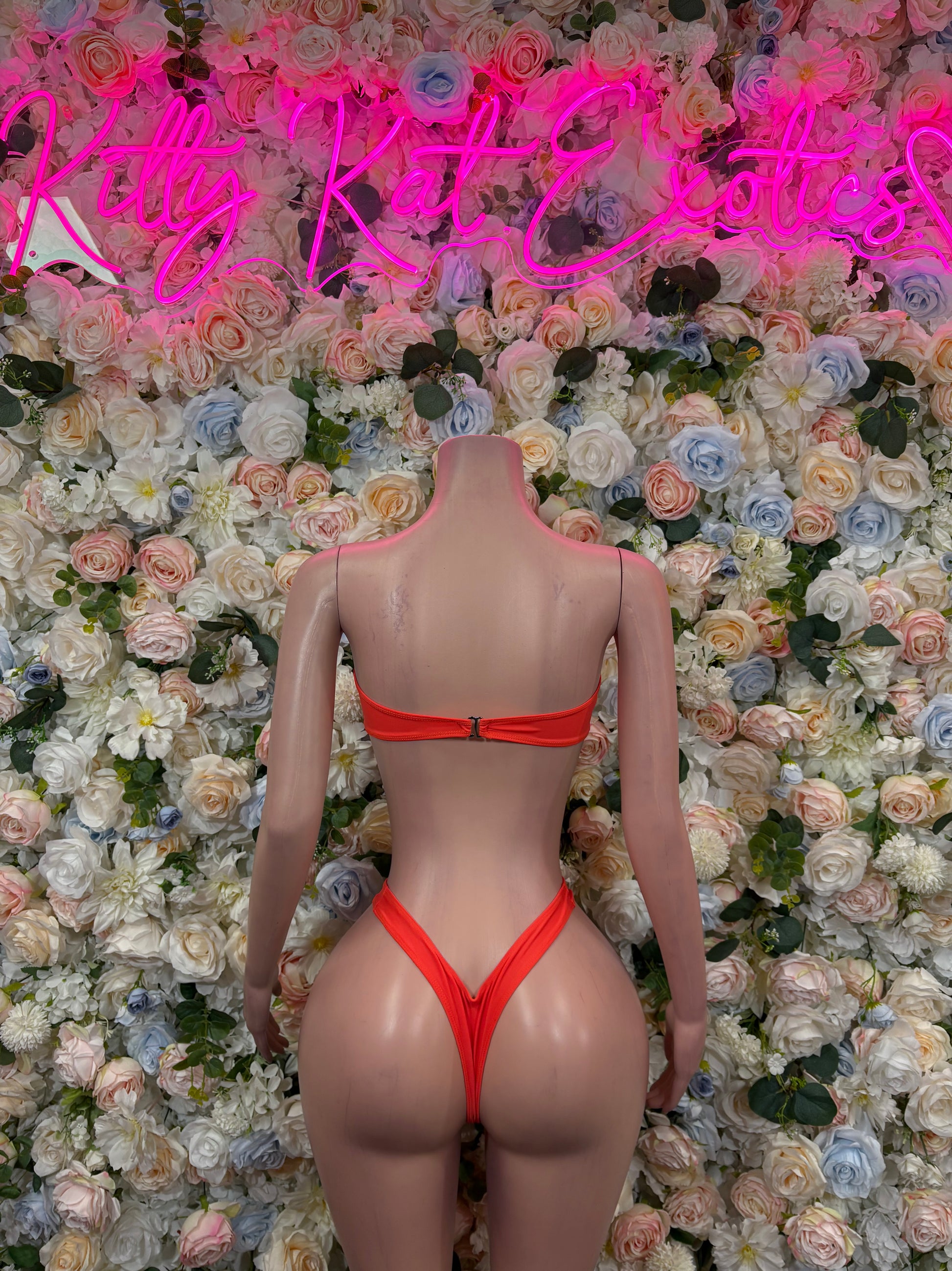 Orange one-piece bodysuit with high-cut legs and bandeau-style back