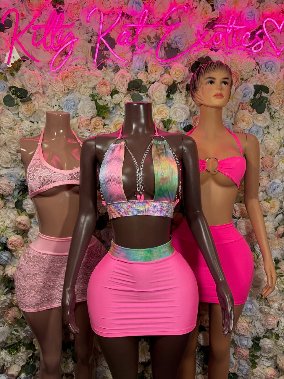 Hot pink o-ring halter crop top and mini skirt two-piece set on mannequin
