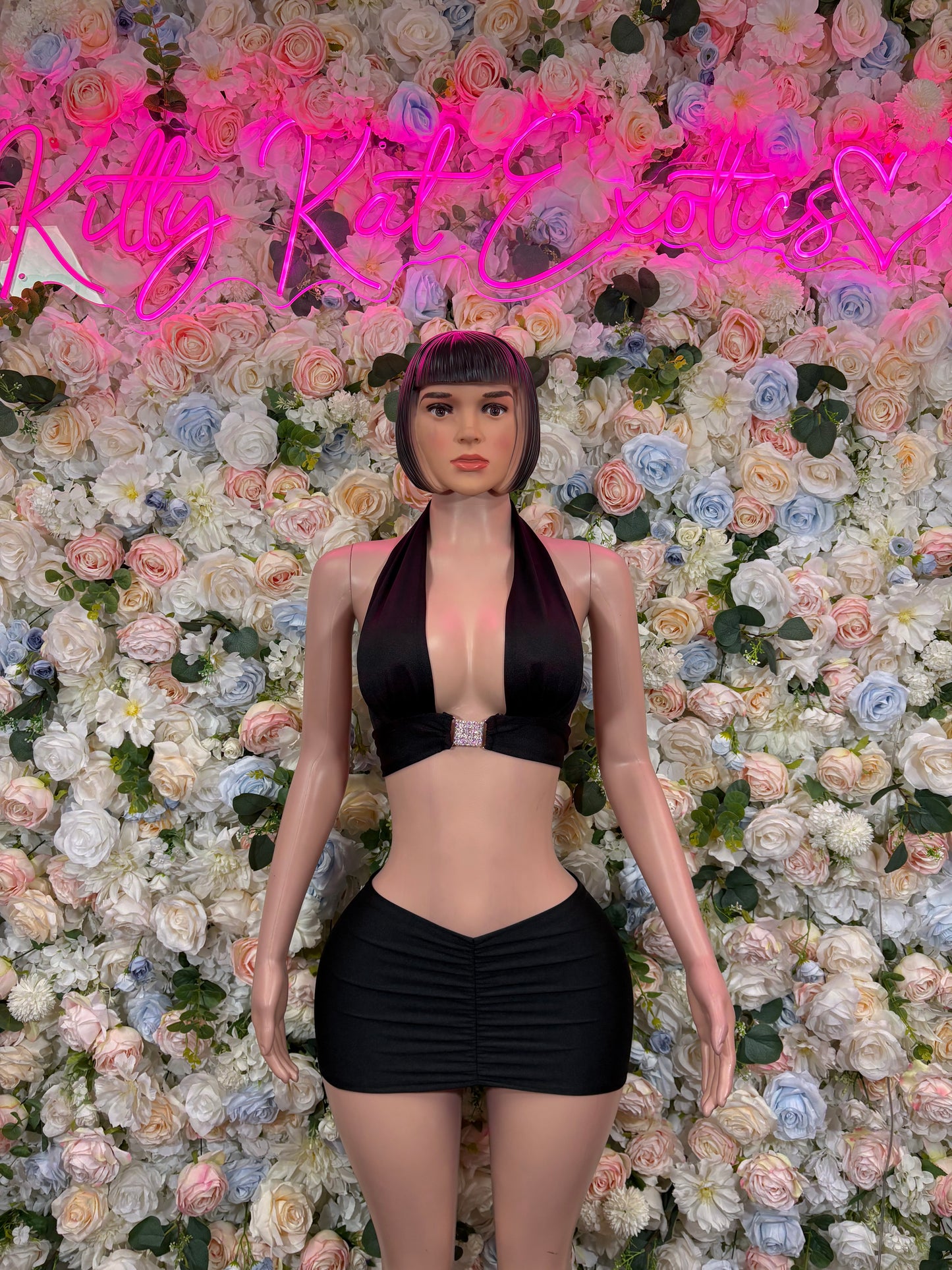 Black halter bodysuit with mini skirt, front view
