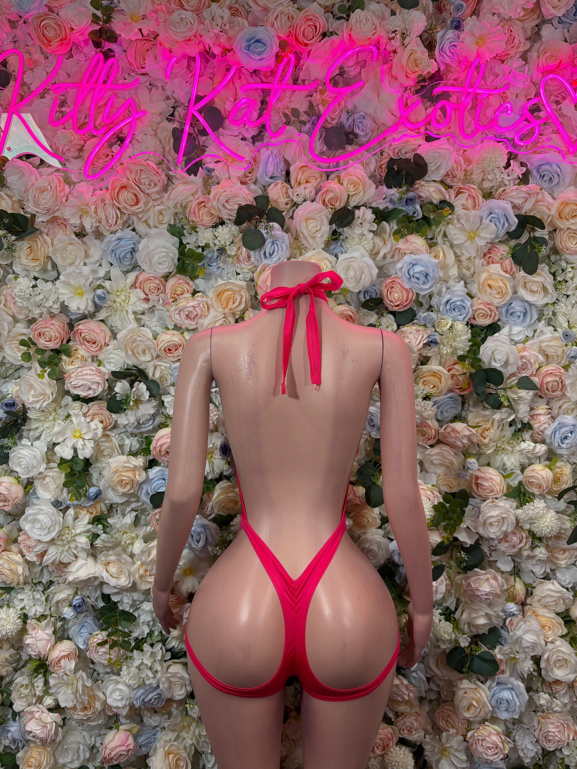 Hot pink halter bodysuit with tie-back detail and high-cut thong bottom