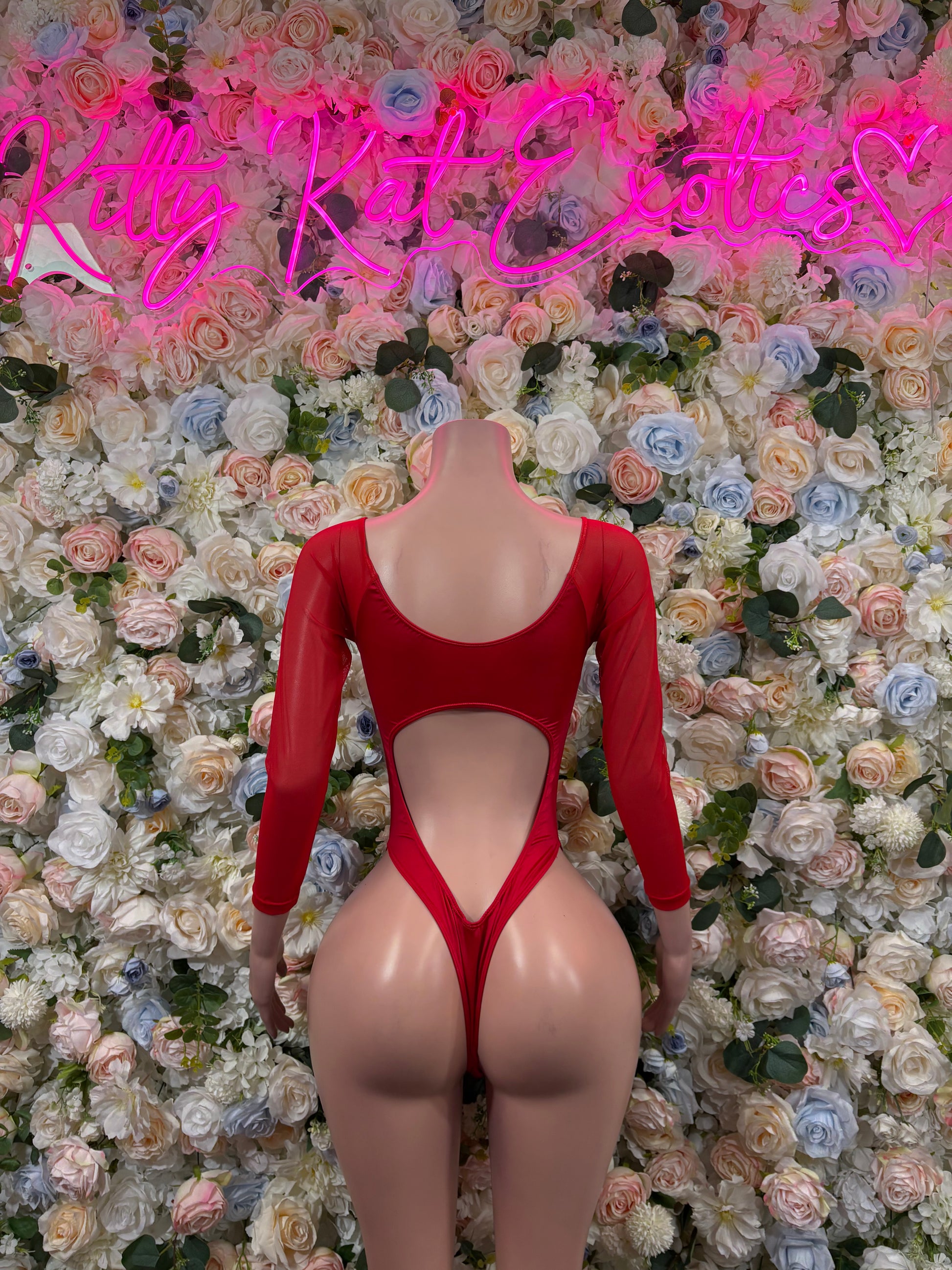 Red long-sleeve bodysuit with U-shaped back cutout and high-leg coverage, sparkly