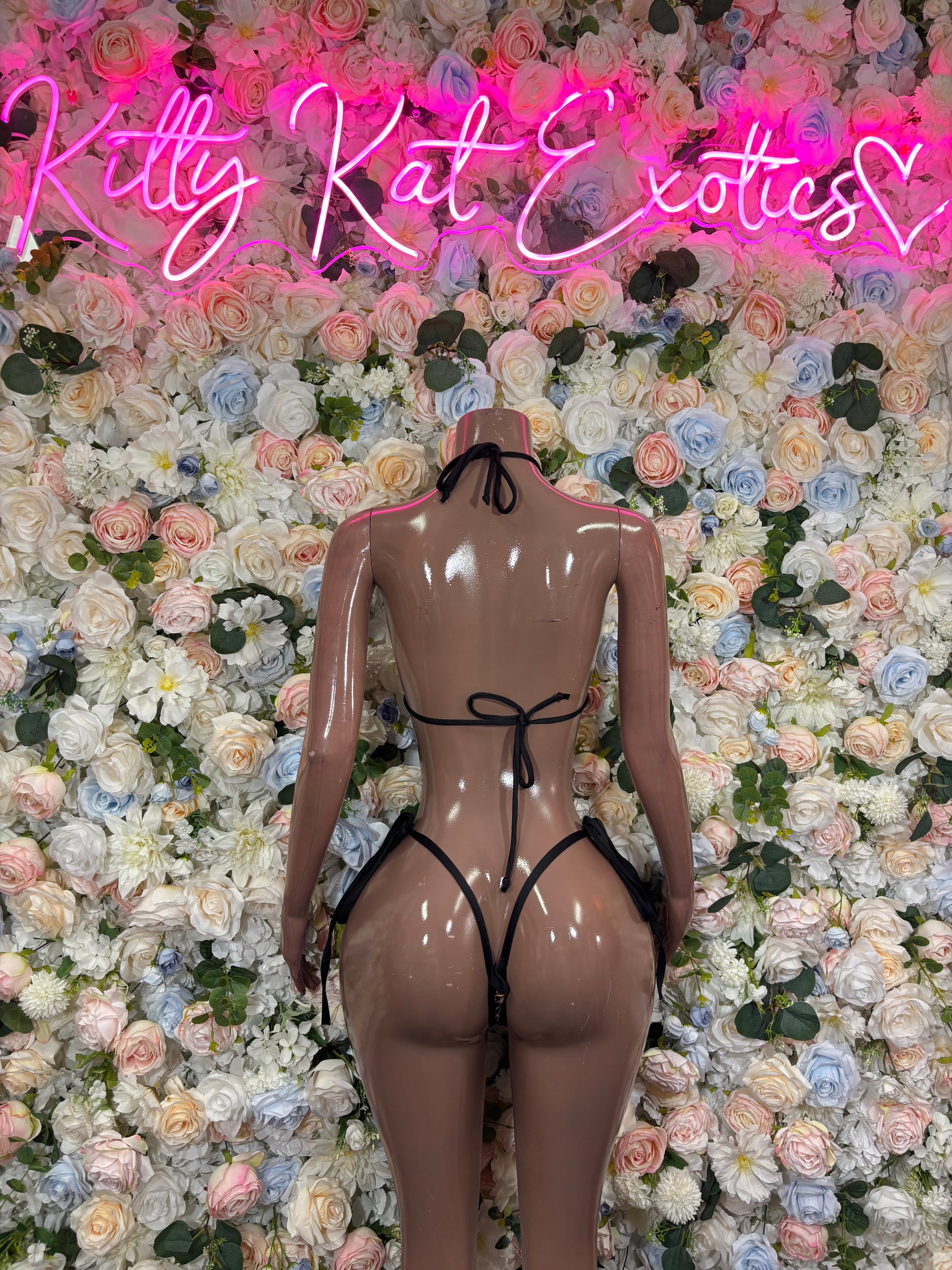 Leopard-print hologram-style bikini set with black straps on mannequin, back view