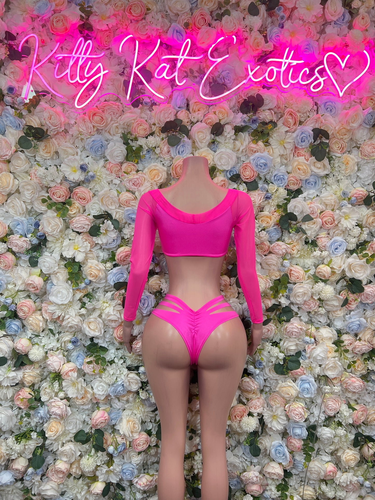 Hot pink two-piece rave swimsuit with long-sleeve crop top and high-cut bottoms