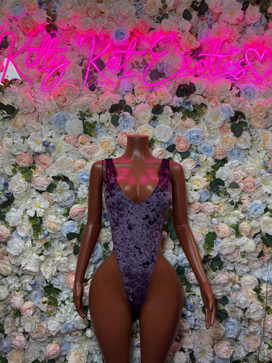 Purple velvet one-piece bodysuit with high-cut legs and deep scoop neckline