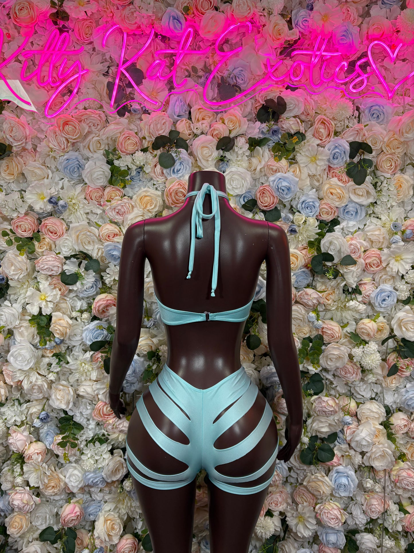 Light blue two-piece rave outfit, back view: halter tie top and striped cutout shorts