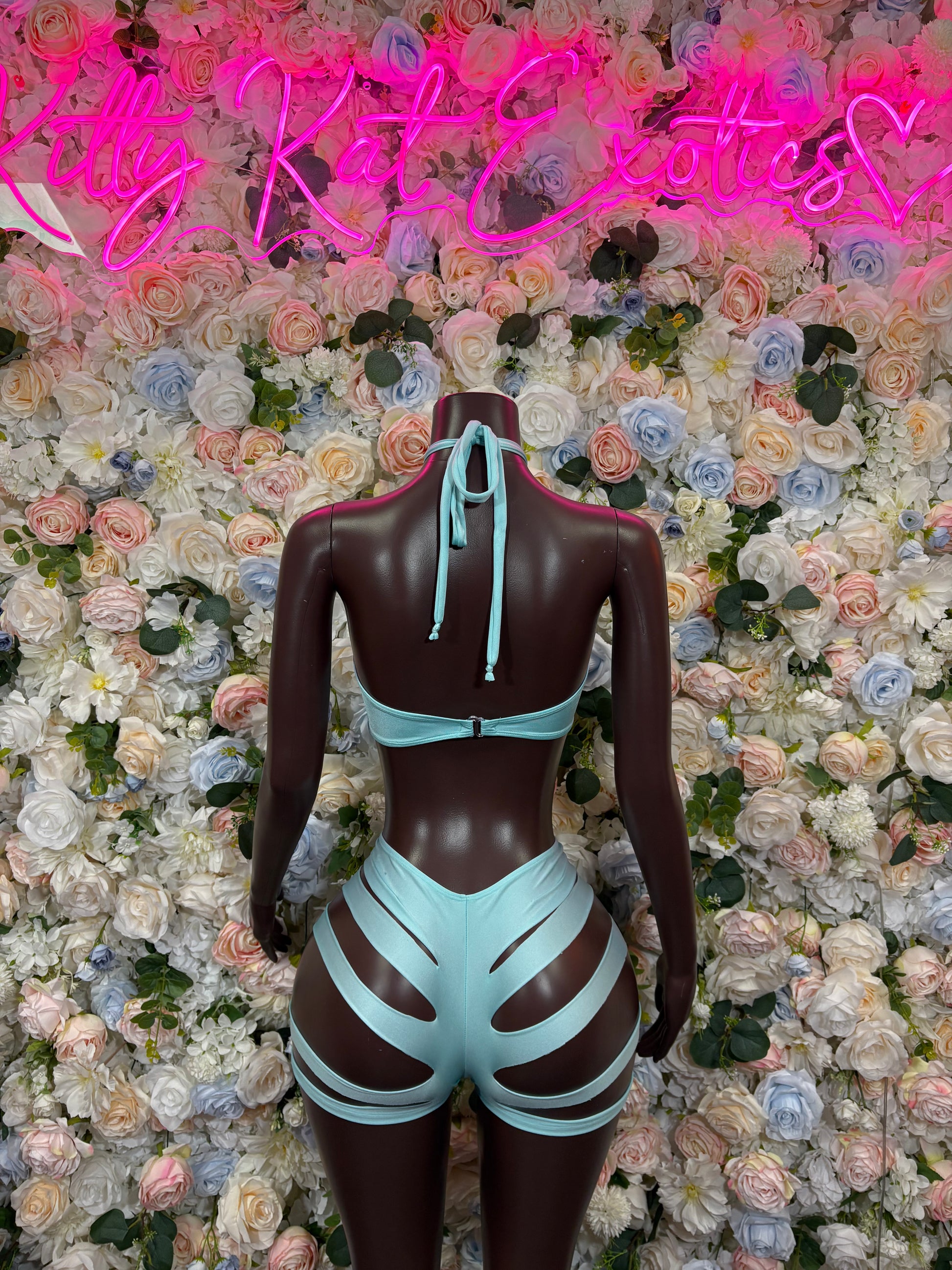 Light blue two-piece rave outfit, back view: halter tie top and striped cutout shorts