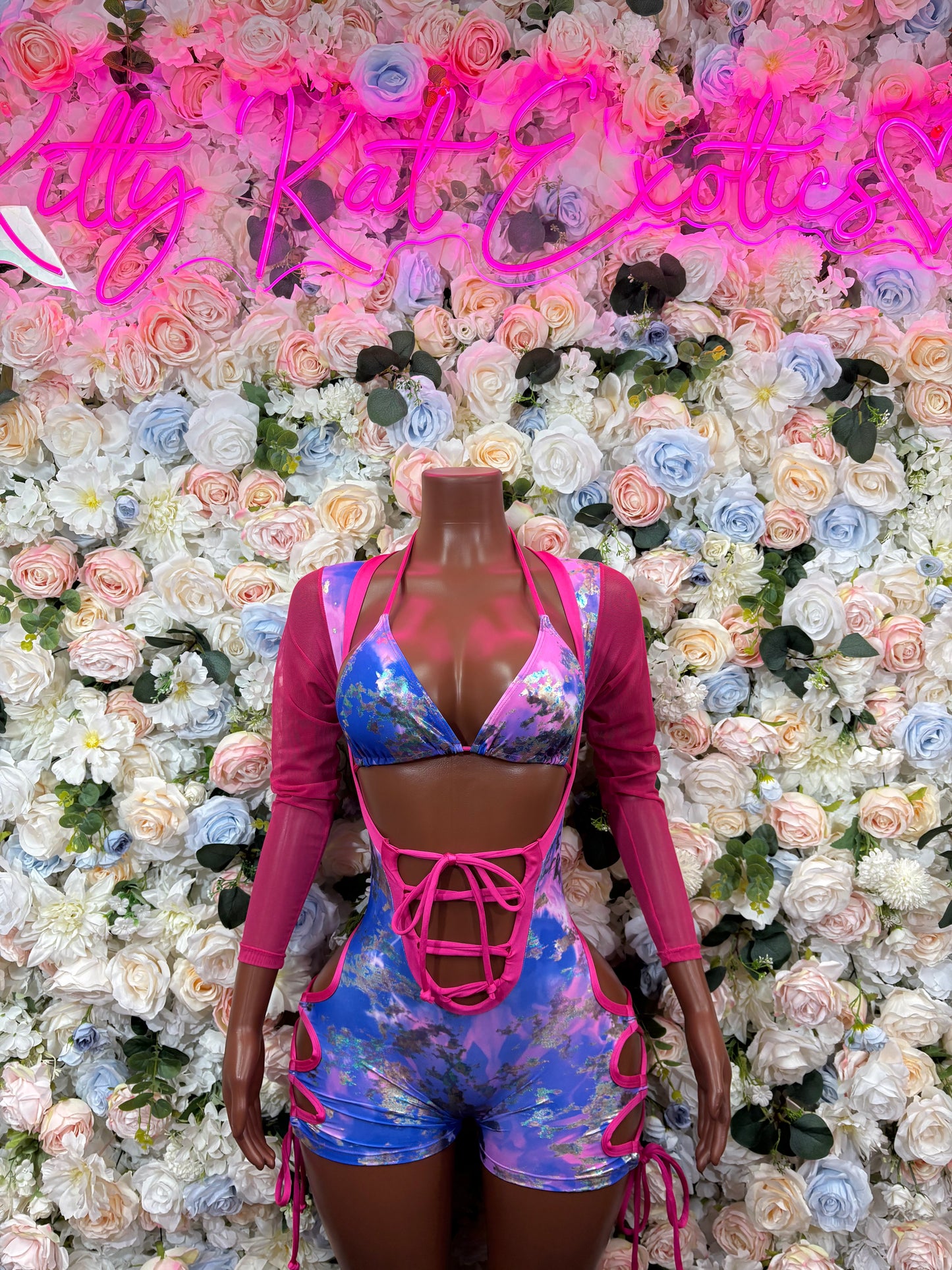 Metallic bodysuit with blue and pink panels, long sleeves, crisscross lace-up front
