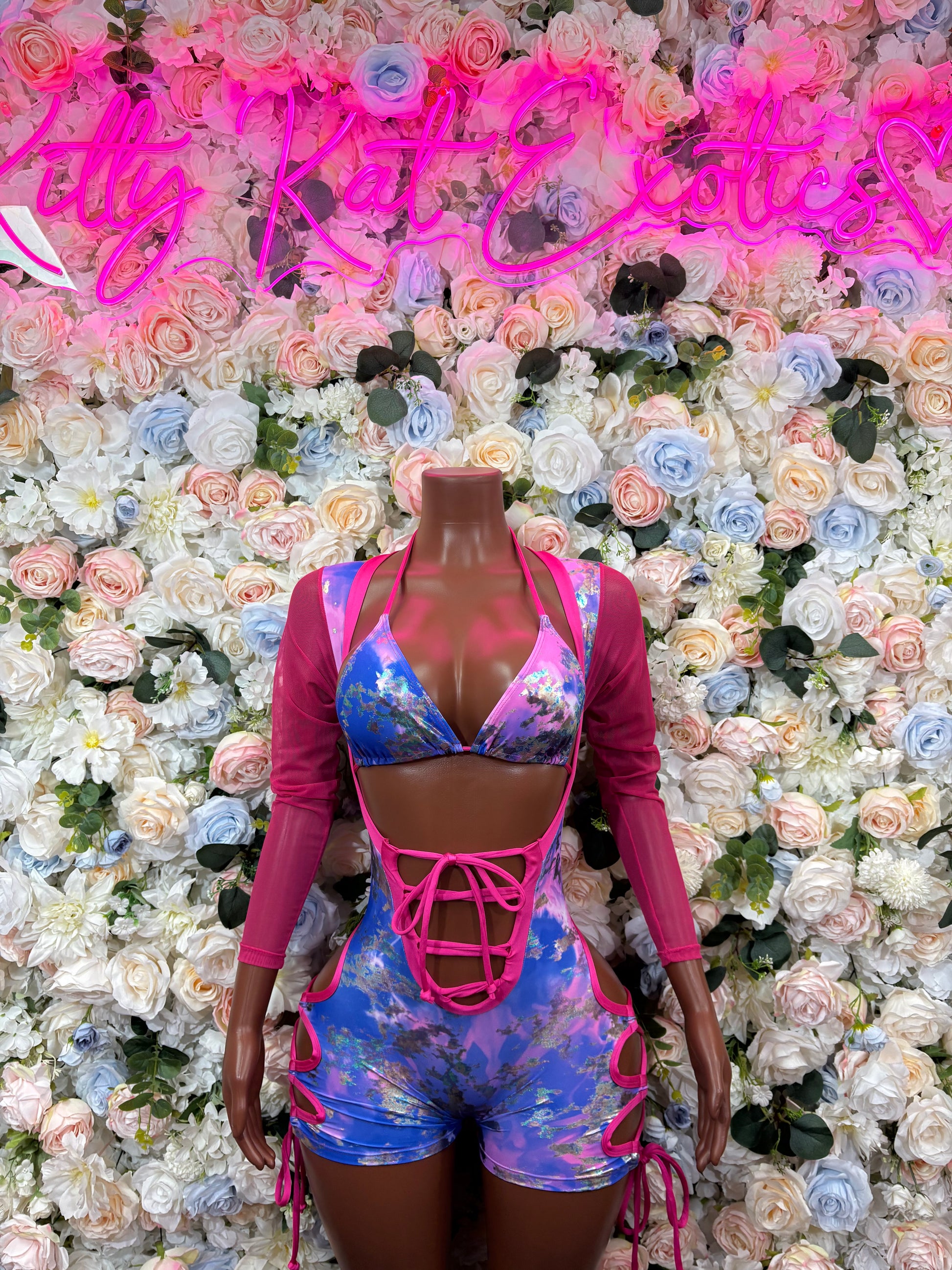 Metallic bodysuit with blue and pink panels, long sleeves, crisscross lace-up front