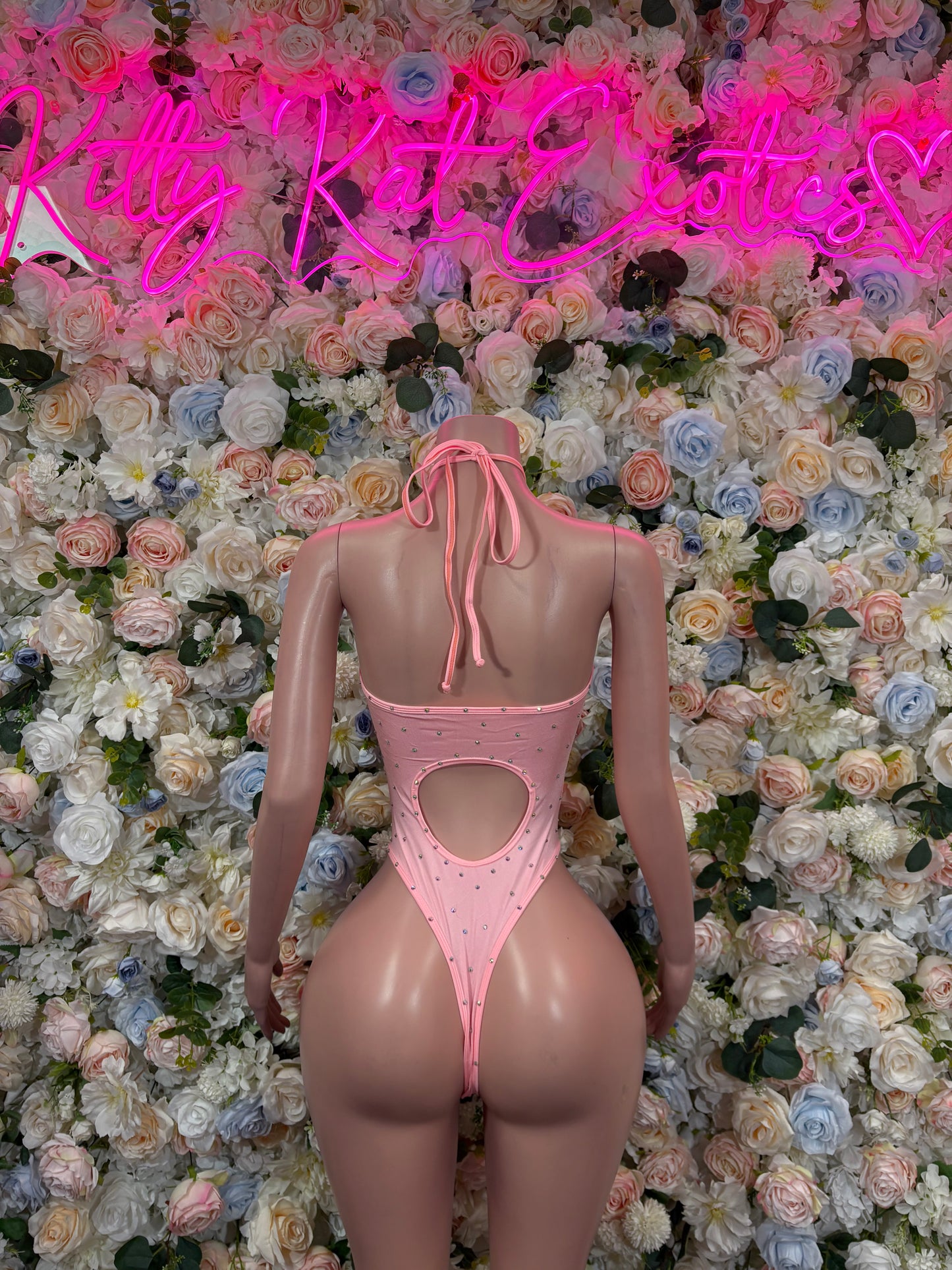 Pink rhinestone festival bodysuit with lace-up back and heart-shaped cutout