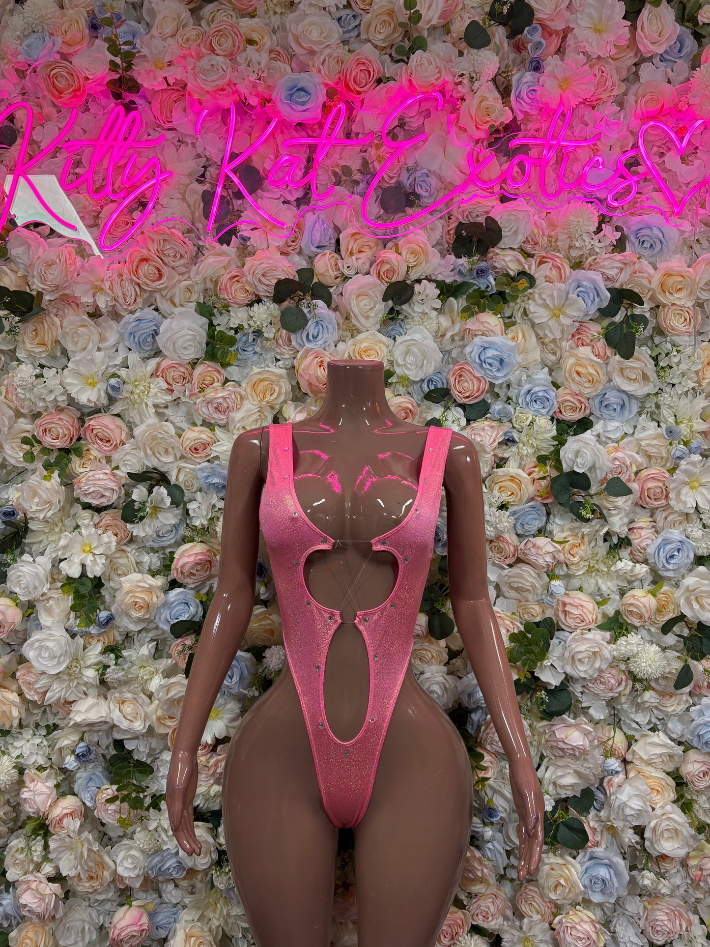 Pink one-piece bodysuit with high-cut legs and open chest cutout