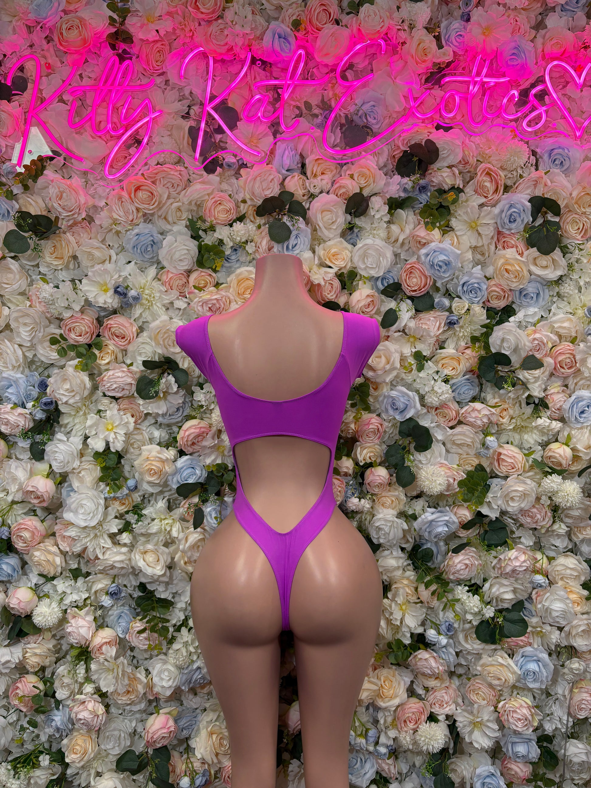 Purple backless one-piece rave bodysuit with cutout lower back and thin straps