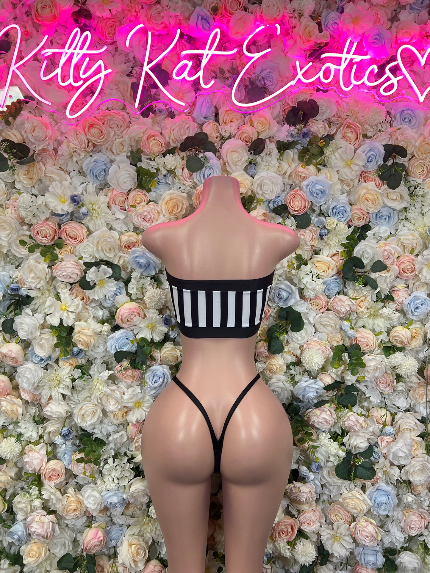 Striped strapless bandeau bikini with black bottoms on mannequin, front view