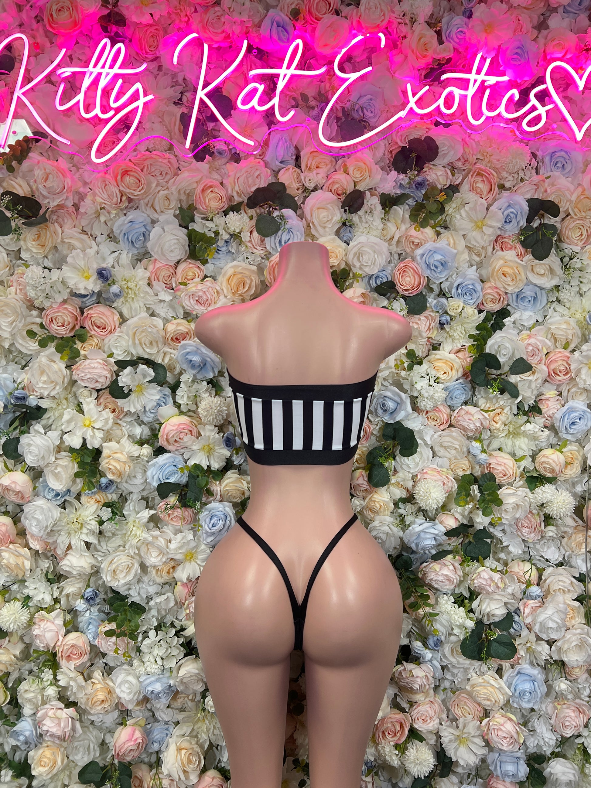 Striped strapless bandeau bikini with black bottoms on mannequin, front view