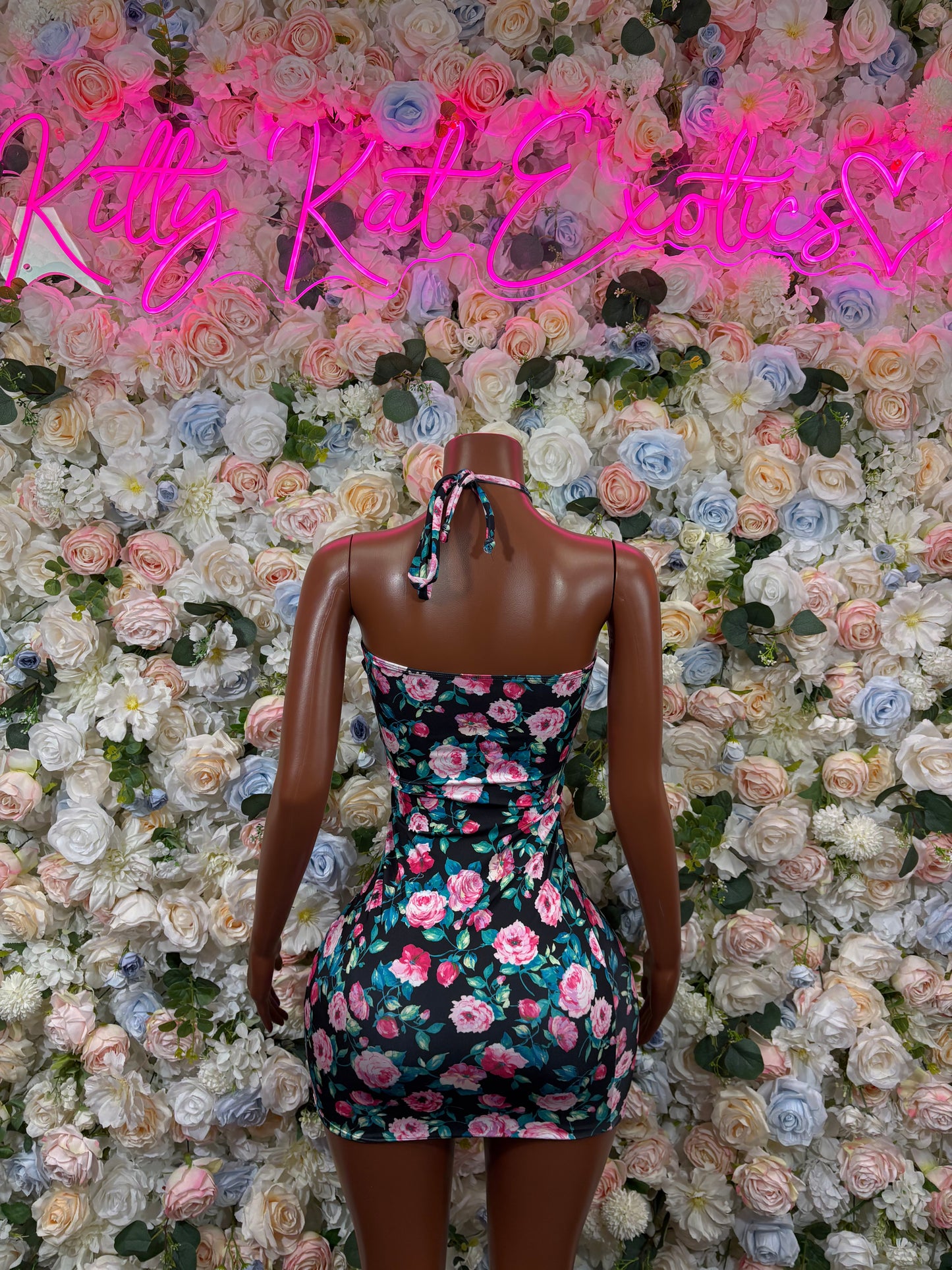 Floral print mini halter dress, tied back straps and cutout back, multicolor flowers on dark base.