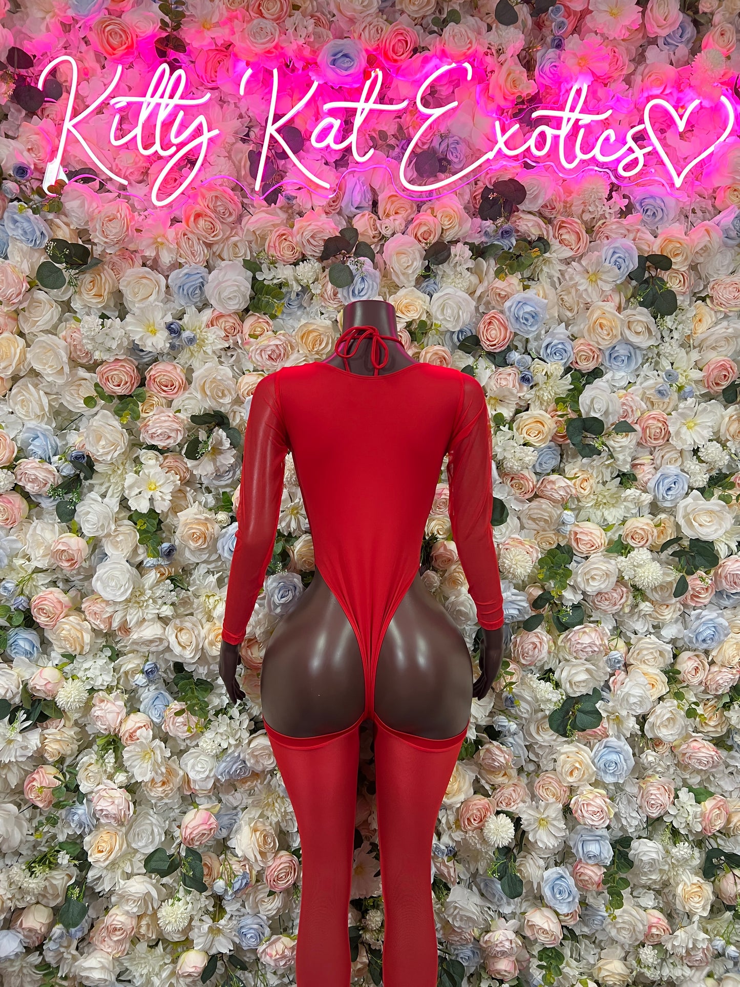 Red lace-up bodysuit with high-cut leg and heart straps, long sleeves
