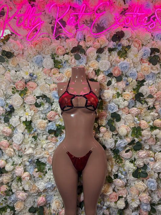 Red and black two-piece lingerie set with strappy triangle top and matching bottoms on mannequin