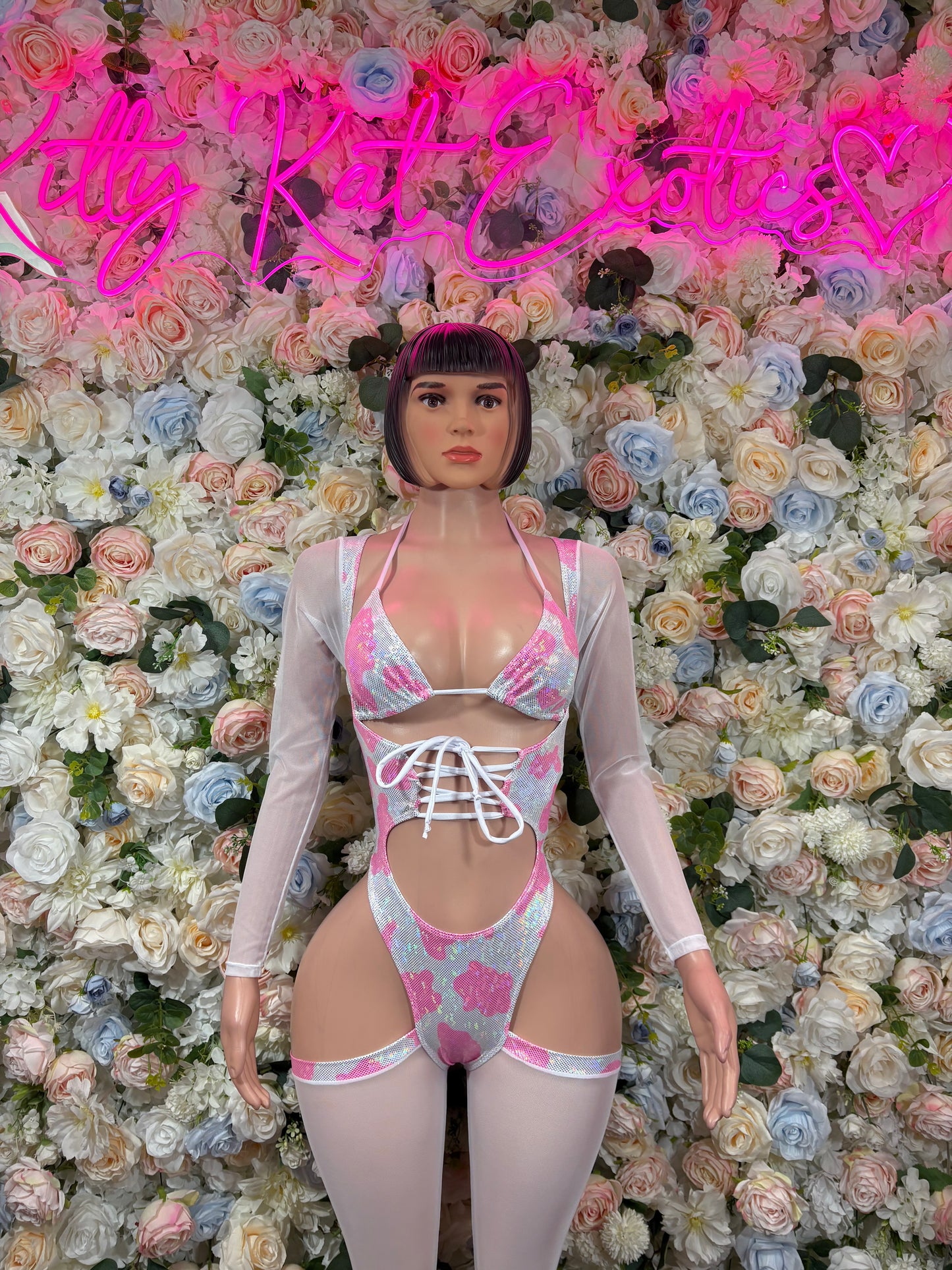 Pink and white patterned bodysuit with lace-up front and long sleeves