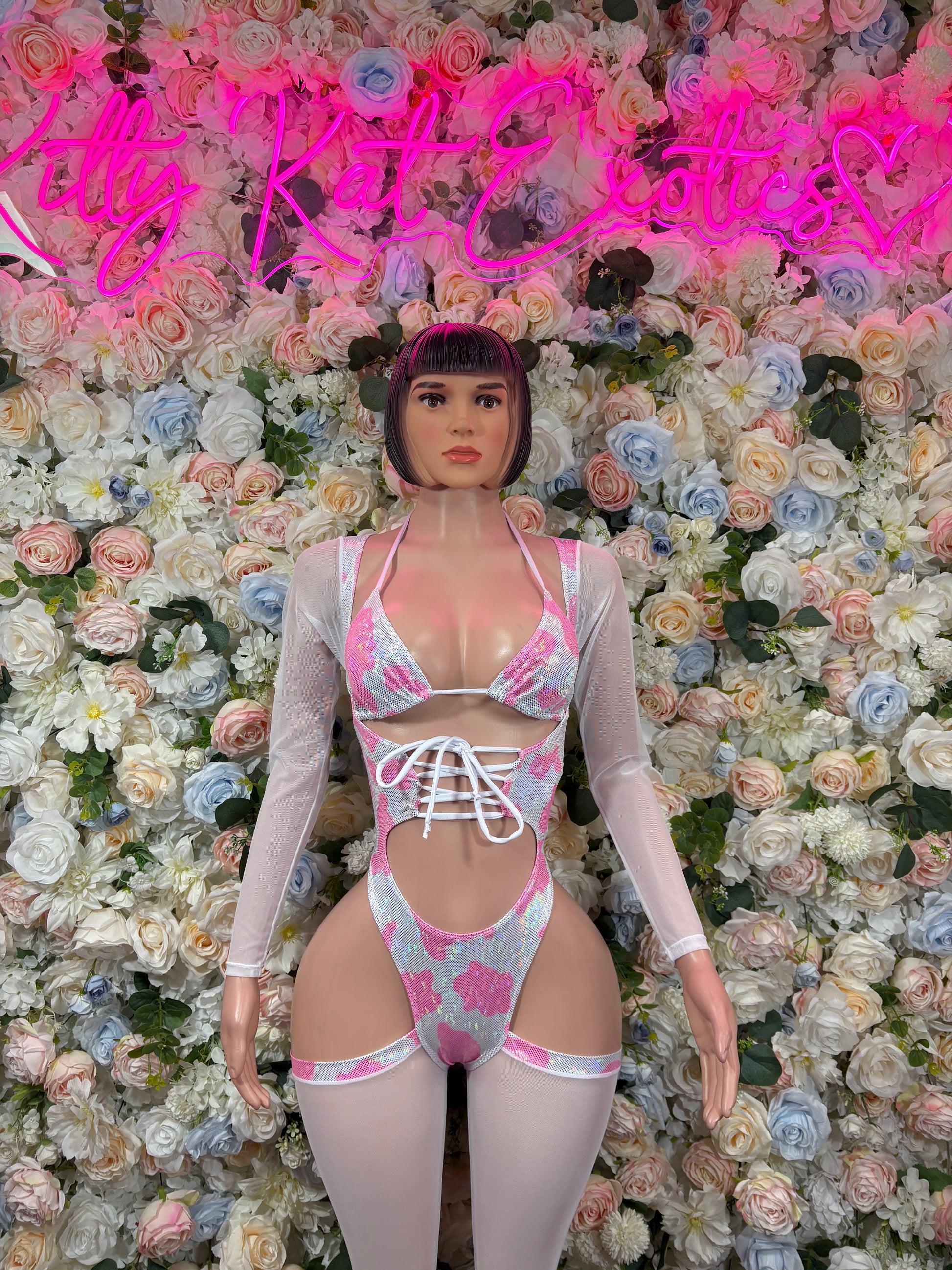 Pink and white patterned bodysuit with lace-up front and long sleeves