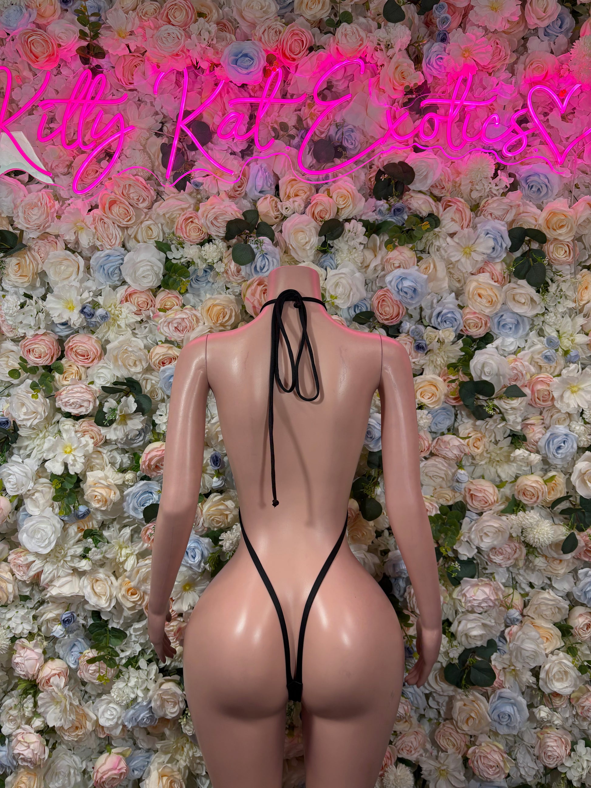 Black fishnet bodysuit with open back and long tie straps