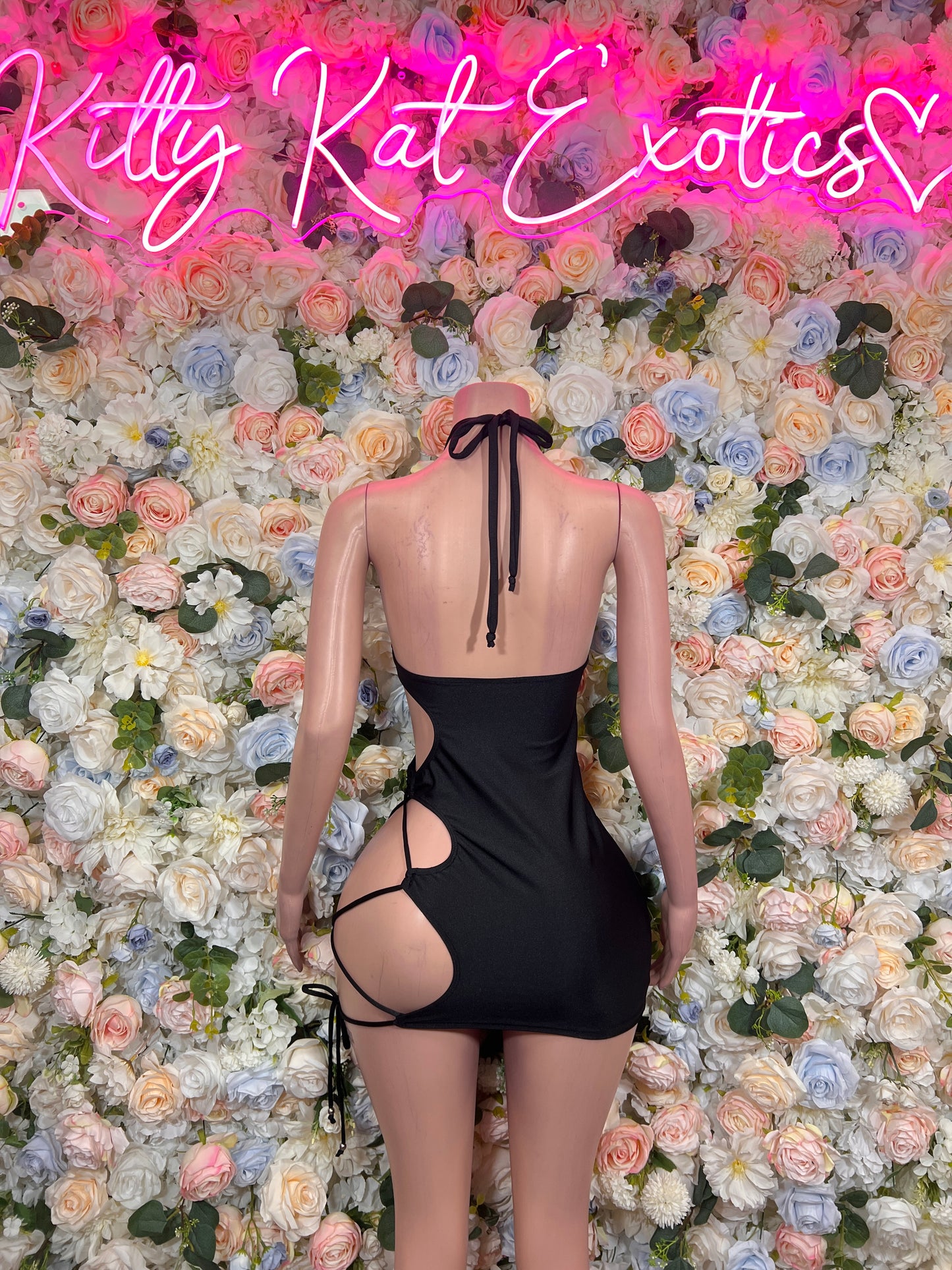 Black cutout halter mini dress with strappy back ties, bodycon fit