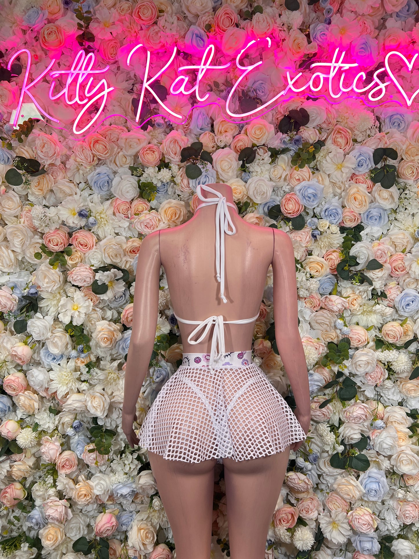 Two-piece skirt set with pink-and-white tie halter top and textured mesh mini skirt