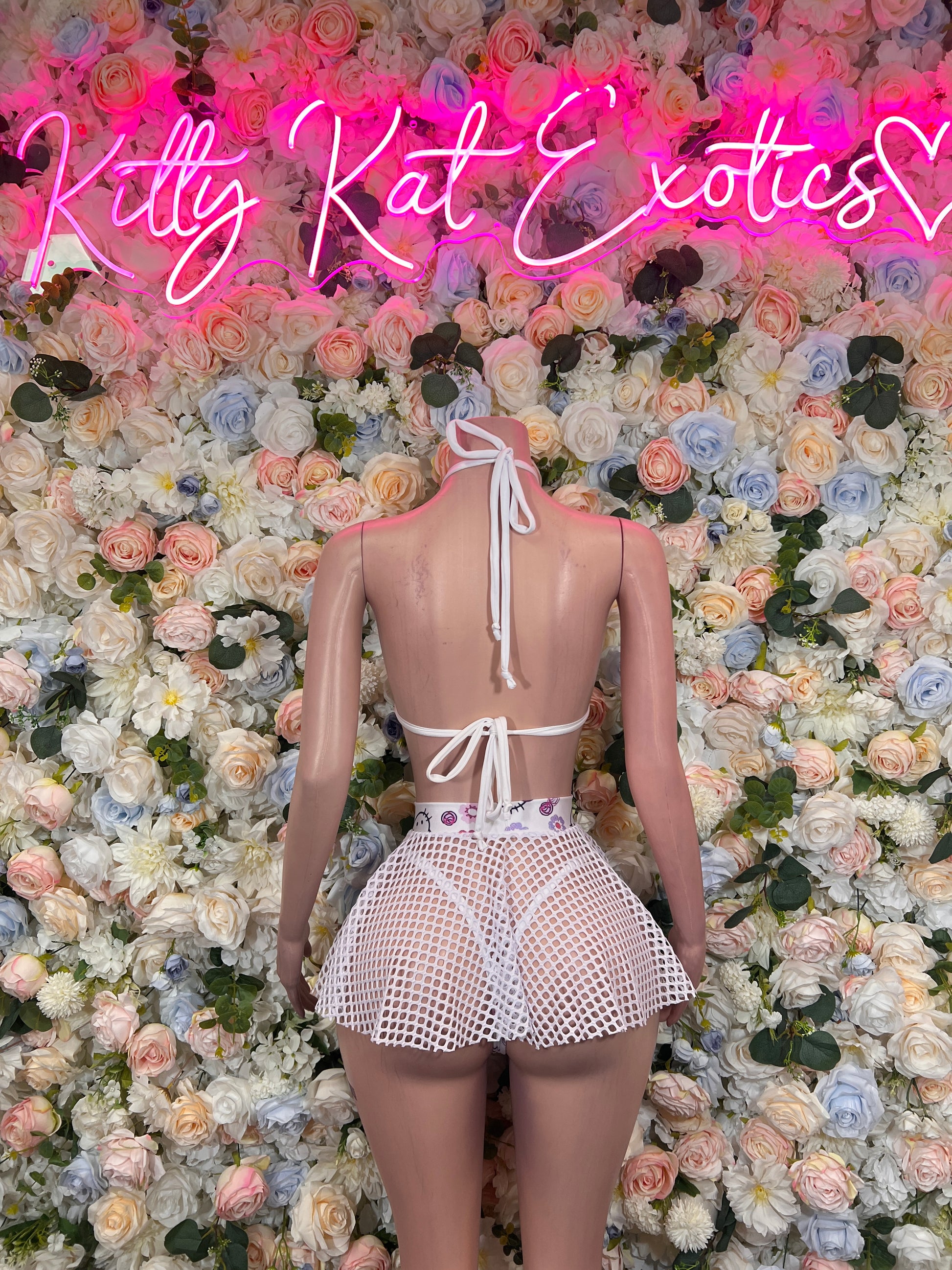 Two-piece skirt set with pink-and-white tie halter top and textured mesh mini skirt