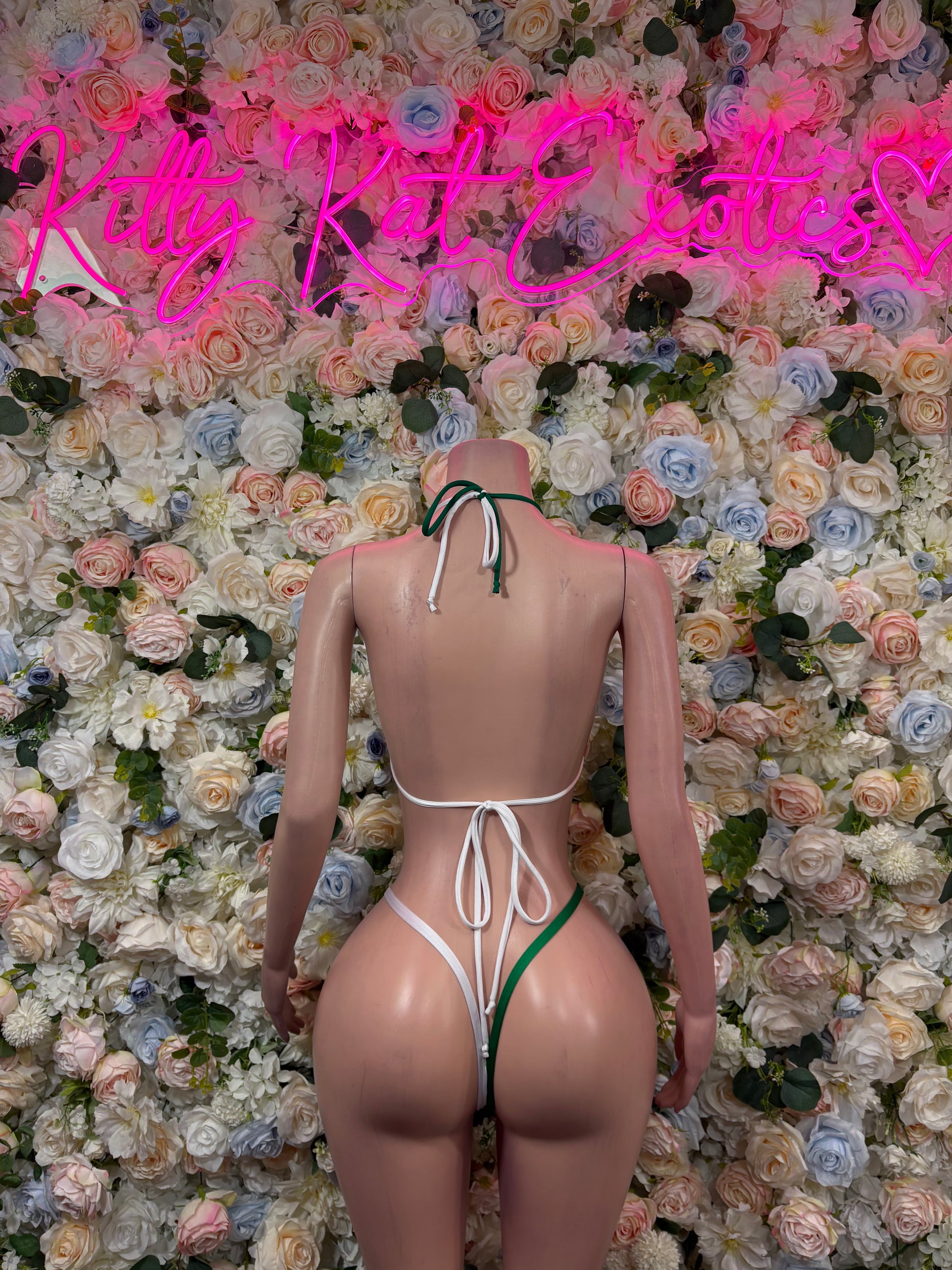 Two-piece bikini set, back view, green ties with red-and-white triangle panels.
