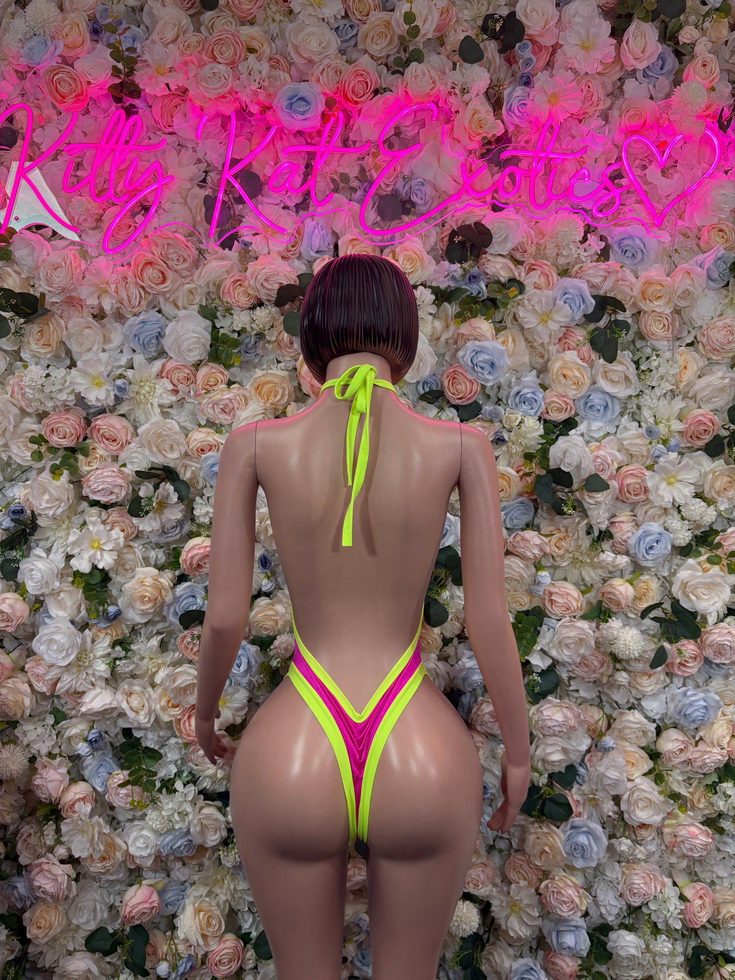 Neon pink and green backless bodysuit with high-cut back and strap ties