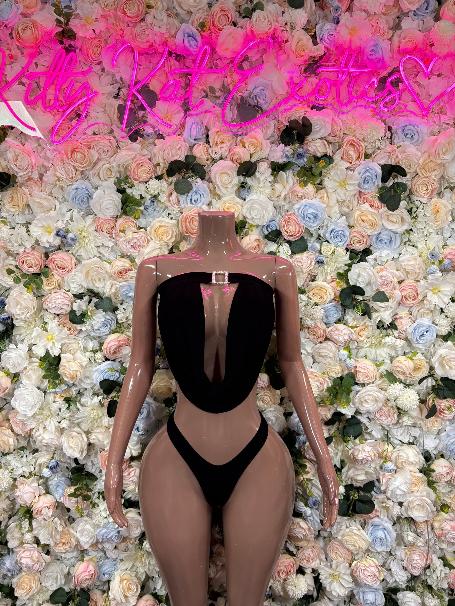 Black two-piece rave bodysuit with deep V halter top and matching high-cut bottoms