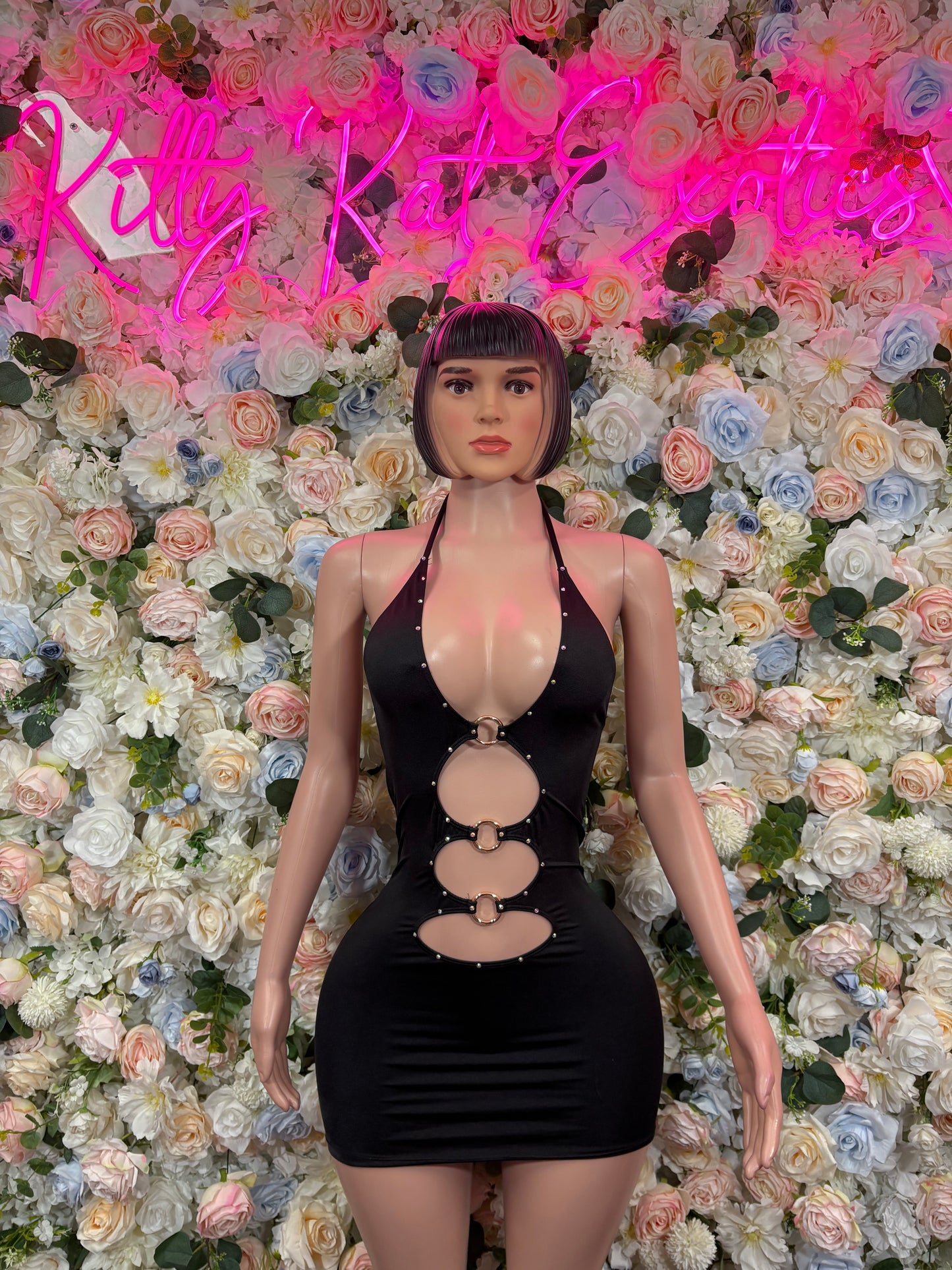 Black halter one-piece dress bodysuit with gold ring cutouts and plunging neckline