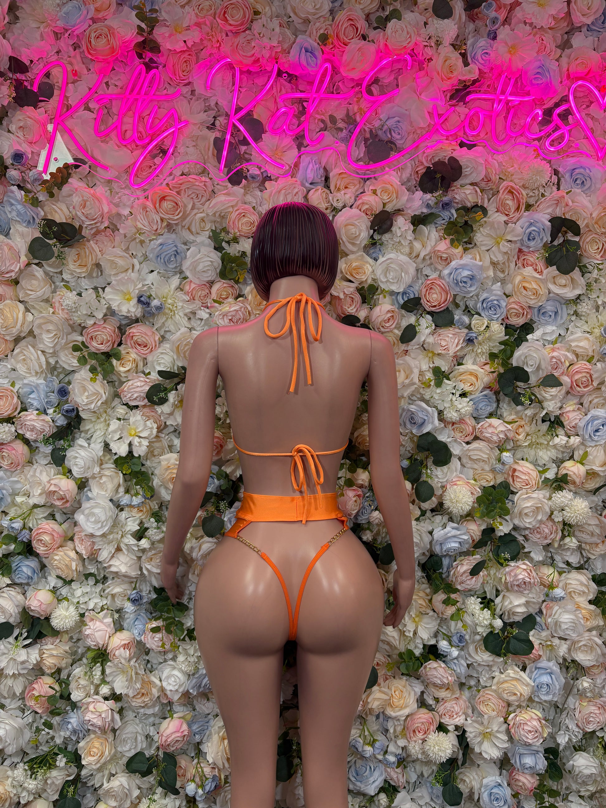 Orange two-piece dancewear set back view, string ties on bikini top and high-waist bottoms