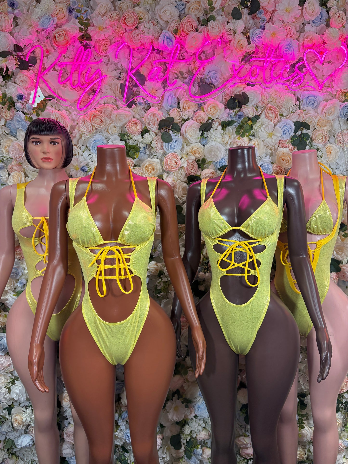 Yellow metallic halter bodysuits with lace-up front shown on multiple mannequins
