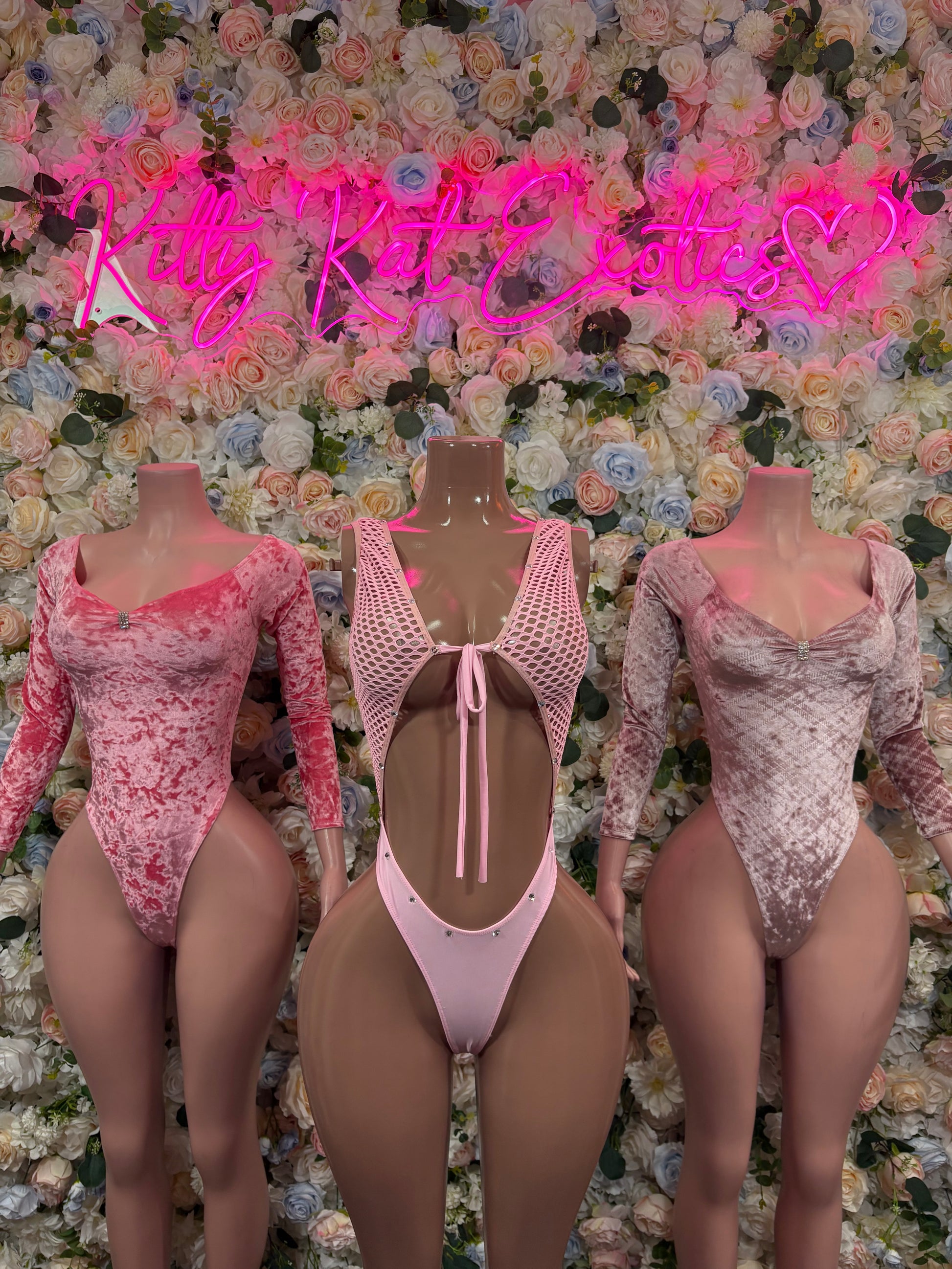 Backless pink velvet bodysuit with long sleeves and open back with straps