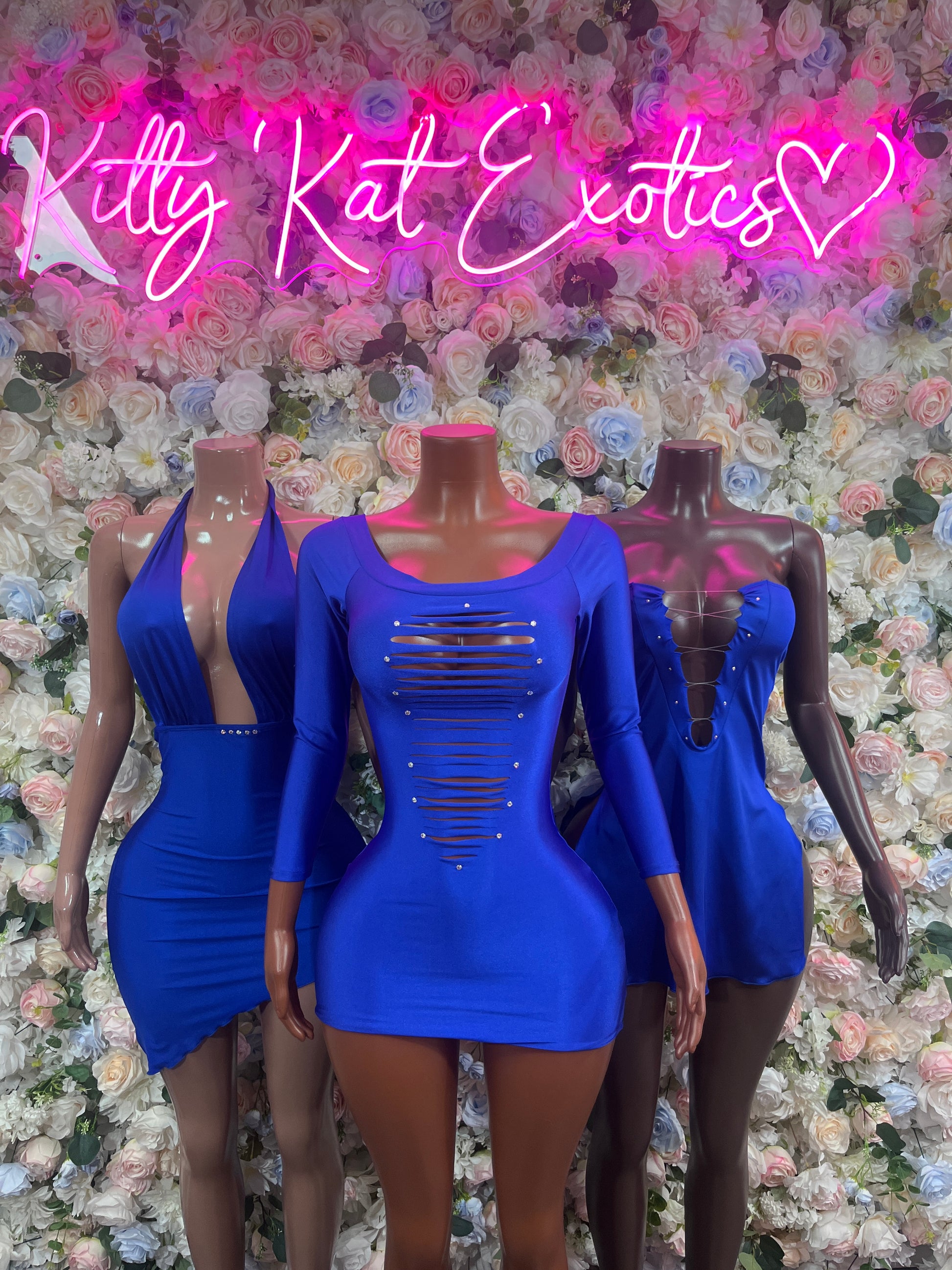 Royal blue long-sleeve mini dresses on mannequins, scoop neckline and ruched chest