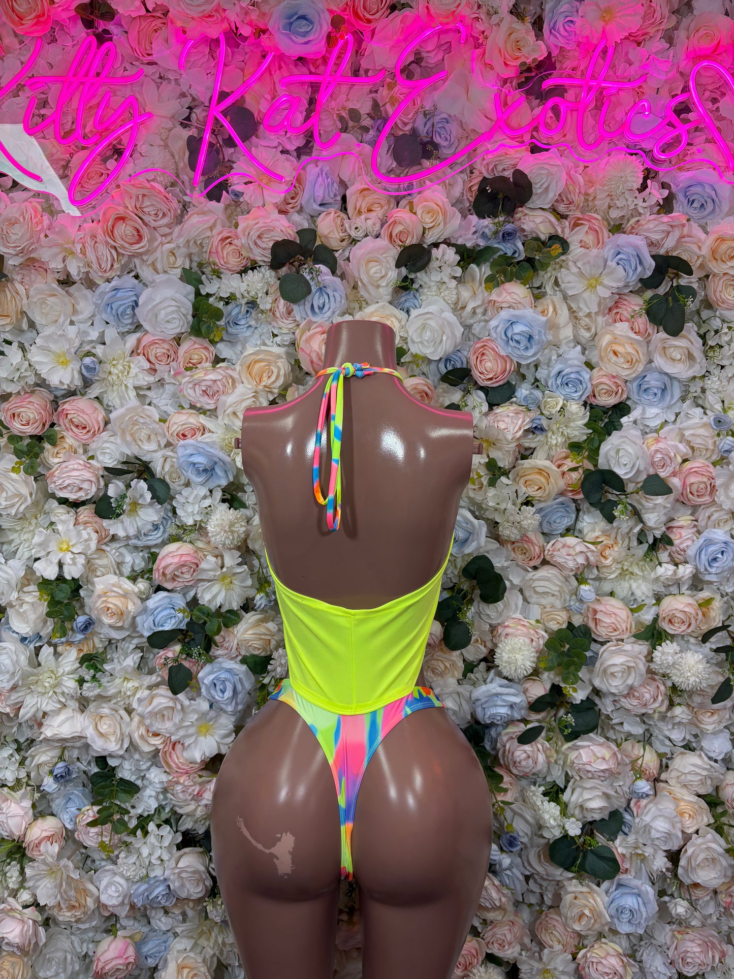 Neon two-piece bikini in lime green with rainbow tie-back straps and thong-style bottom