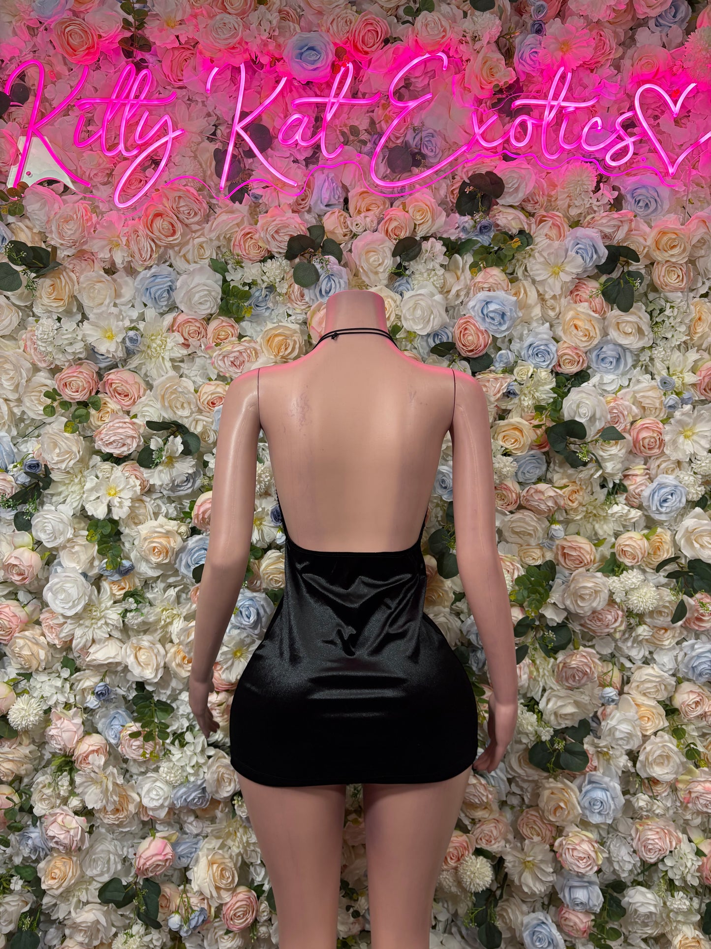 Black one-piece dress bodysuit with low open-back design and thin shoulder straps