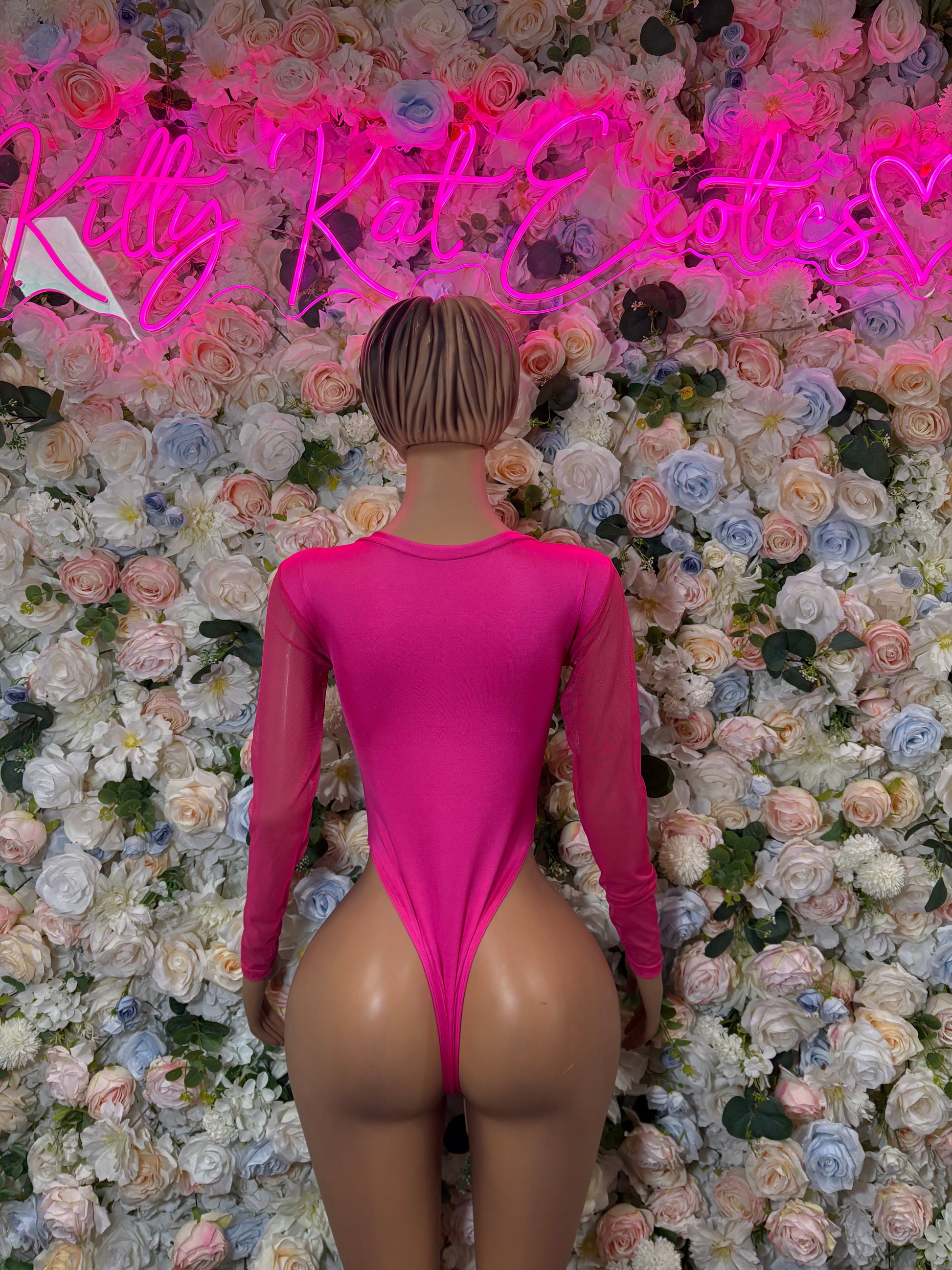 Hot pink long-sleeve bodysuit, open back with V-shaped waist cutout, fitted stretch fabric