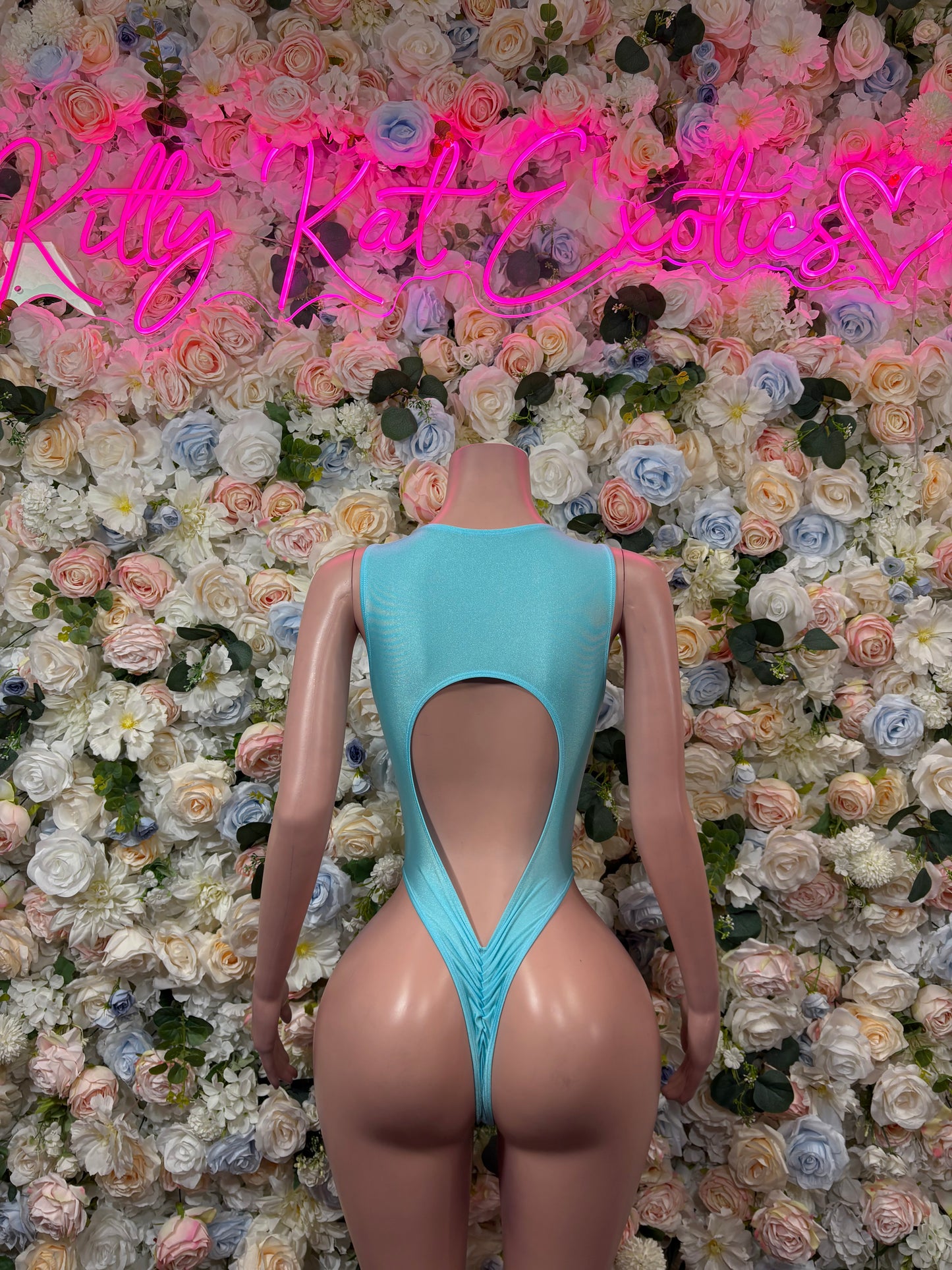 Teal backless lace-up bodysuit with oval cutout and crisscross straps