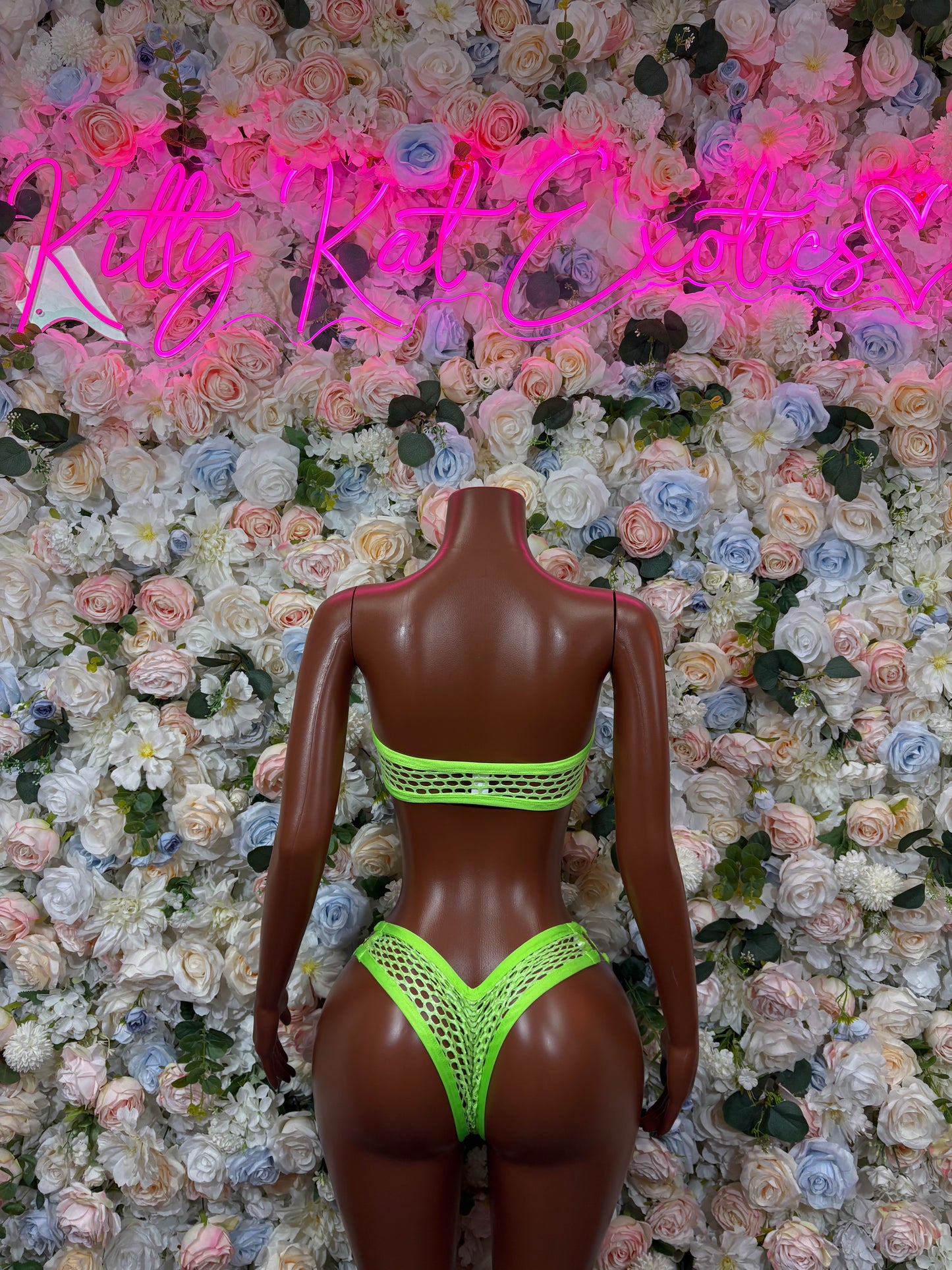 Neon green fishnet bikini set on mannequin, open-back scoop and high-cut bottoms
