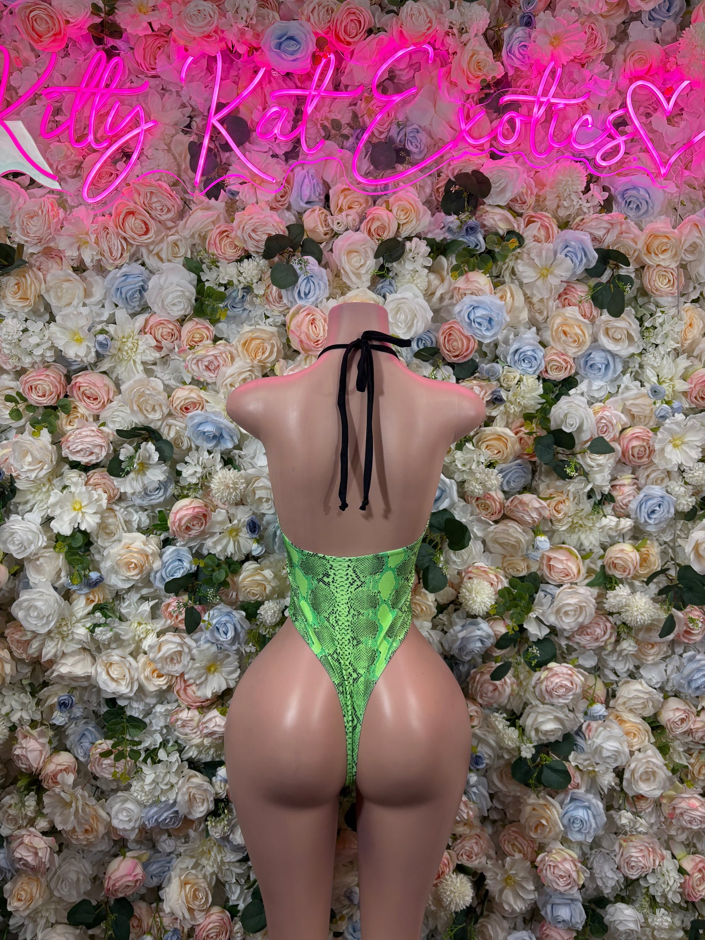 Green snake-print open-back bodysuit with tie straps and high-cut legs