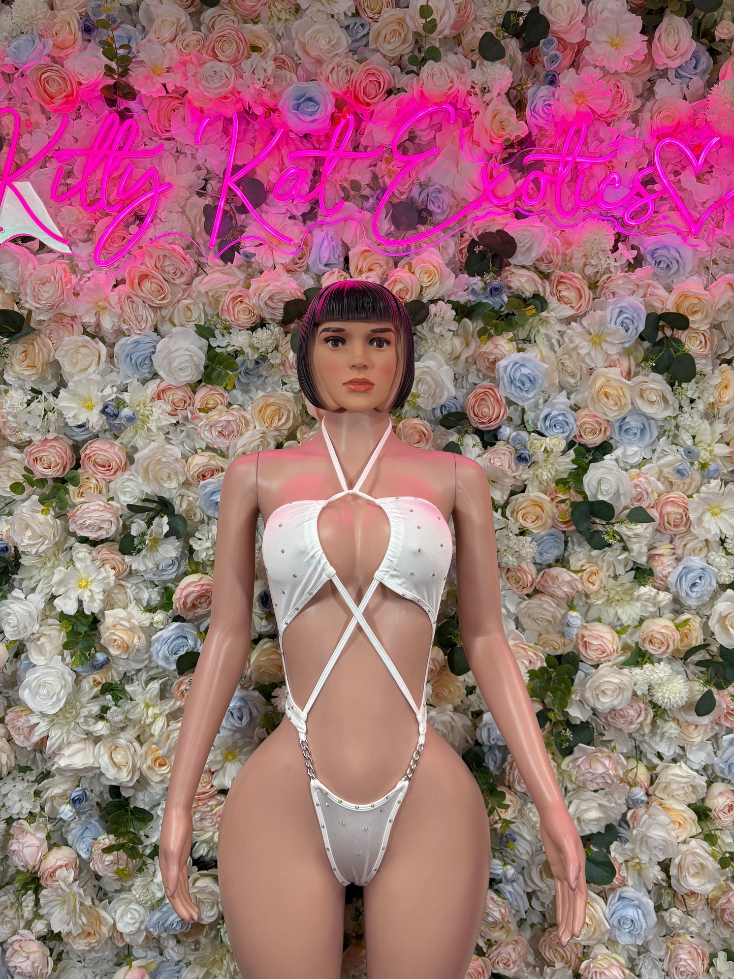 White rhinestone halter bodysuit with crisscross straps and chain detail