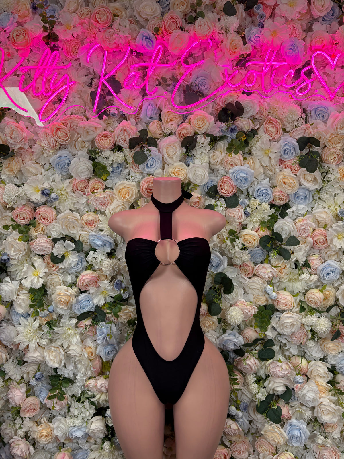 Black one-piece bodysuit with halter neckline and deep V front cutout