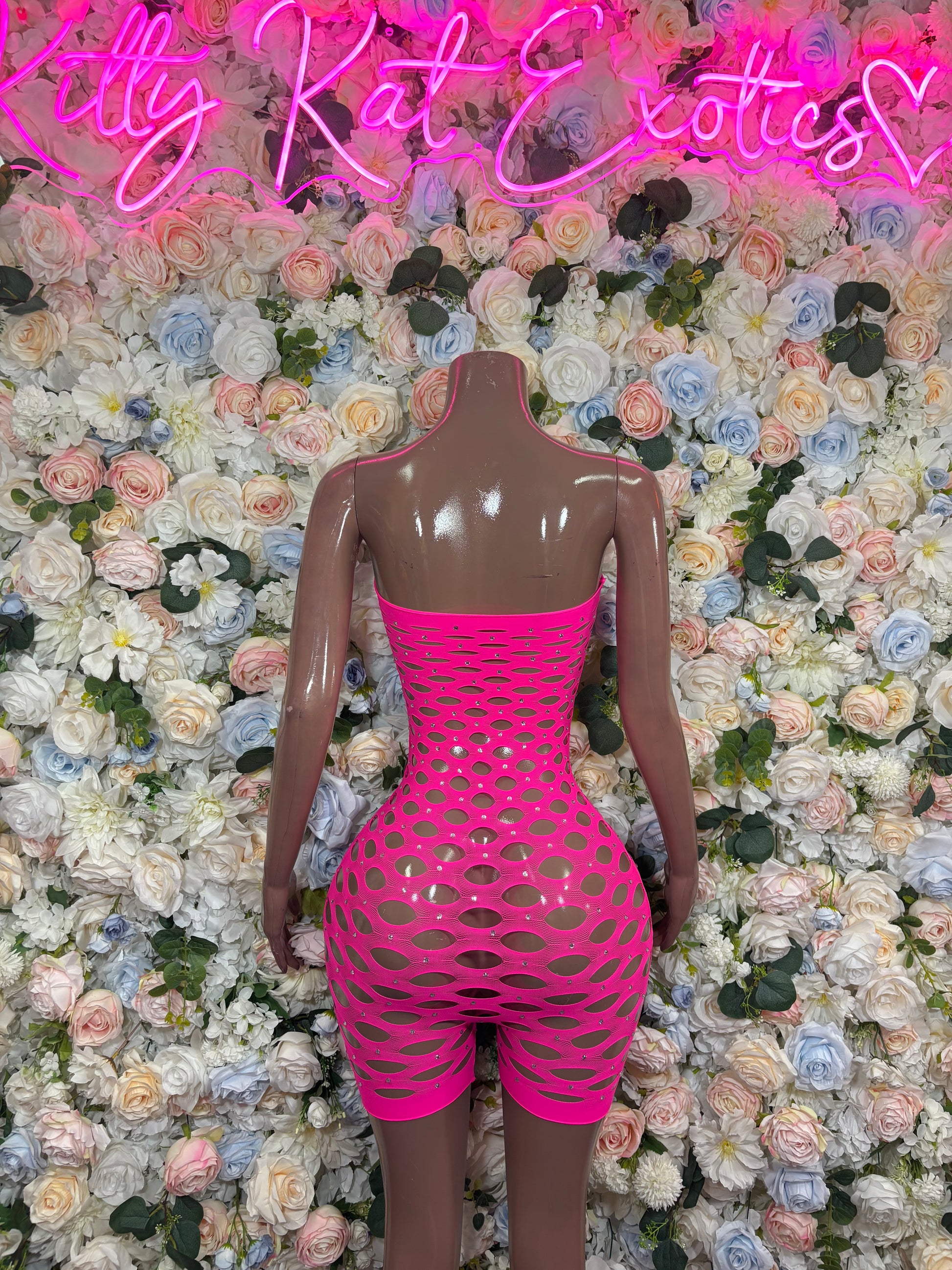 Hot pink fishnet strapless romper with circular pattern and open-back cutout